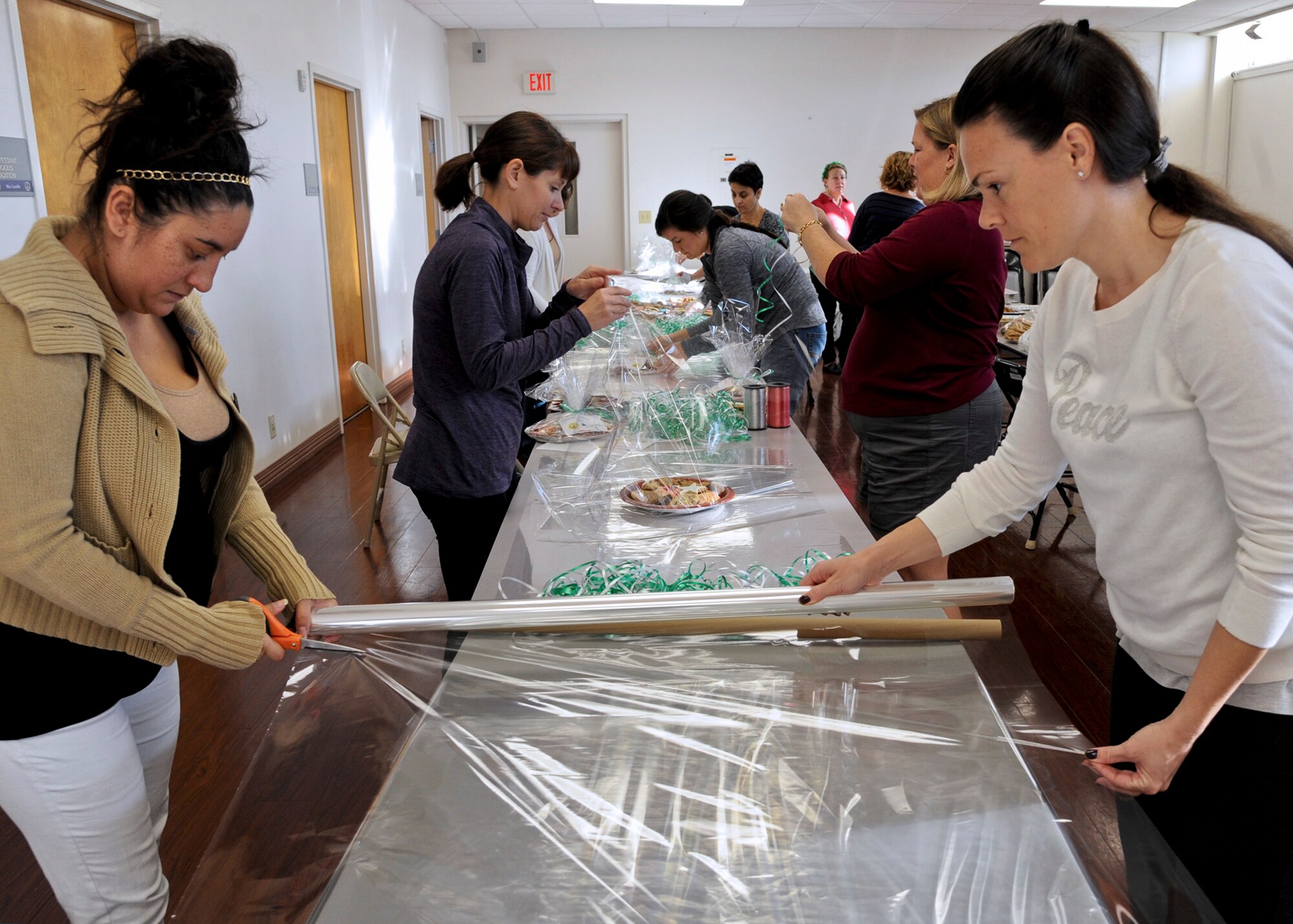 Members of the officers’ and the enlisted spouses’ clubs at MacDill Air Force Base, Fla., package plates of homemade cookies for dorm residents in the base chapel annex for Operation Cookie Drop 2015 Dec. 8, 2015. The members spent four hours packaging the cookies for delivery. (U.S. Air Force photo by Senior Airman Danielle Quilla)