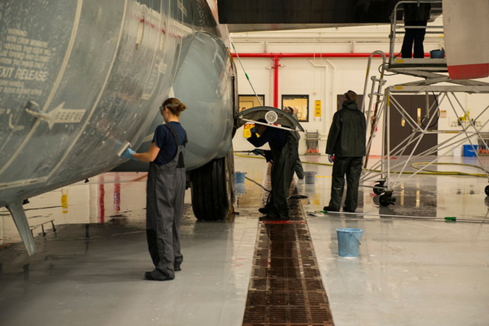 Sailors from Fleet Logistics Support Squadron 64 scrub the exterior of a C-130 Hercules on Joint Base McGuire-Dix-Lakehurst, N.J. Dec. 9. The Sailors wash each of their 5 C-130's every 105 days to protect from corrosion. 