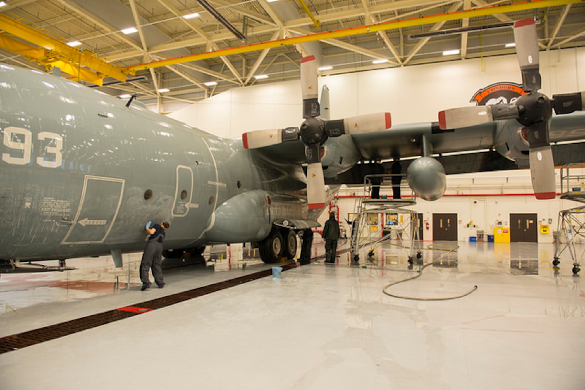 Sailors from Fleet Logistics Support Squadron 64 scrub the exterior of a C-130 Hercules on Joint Base McGuire-Dix-Lakehurst, N.J. Dec. 9. The Sailors wash each of their 5 C-130's every 105 days to protect from corrosion. 