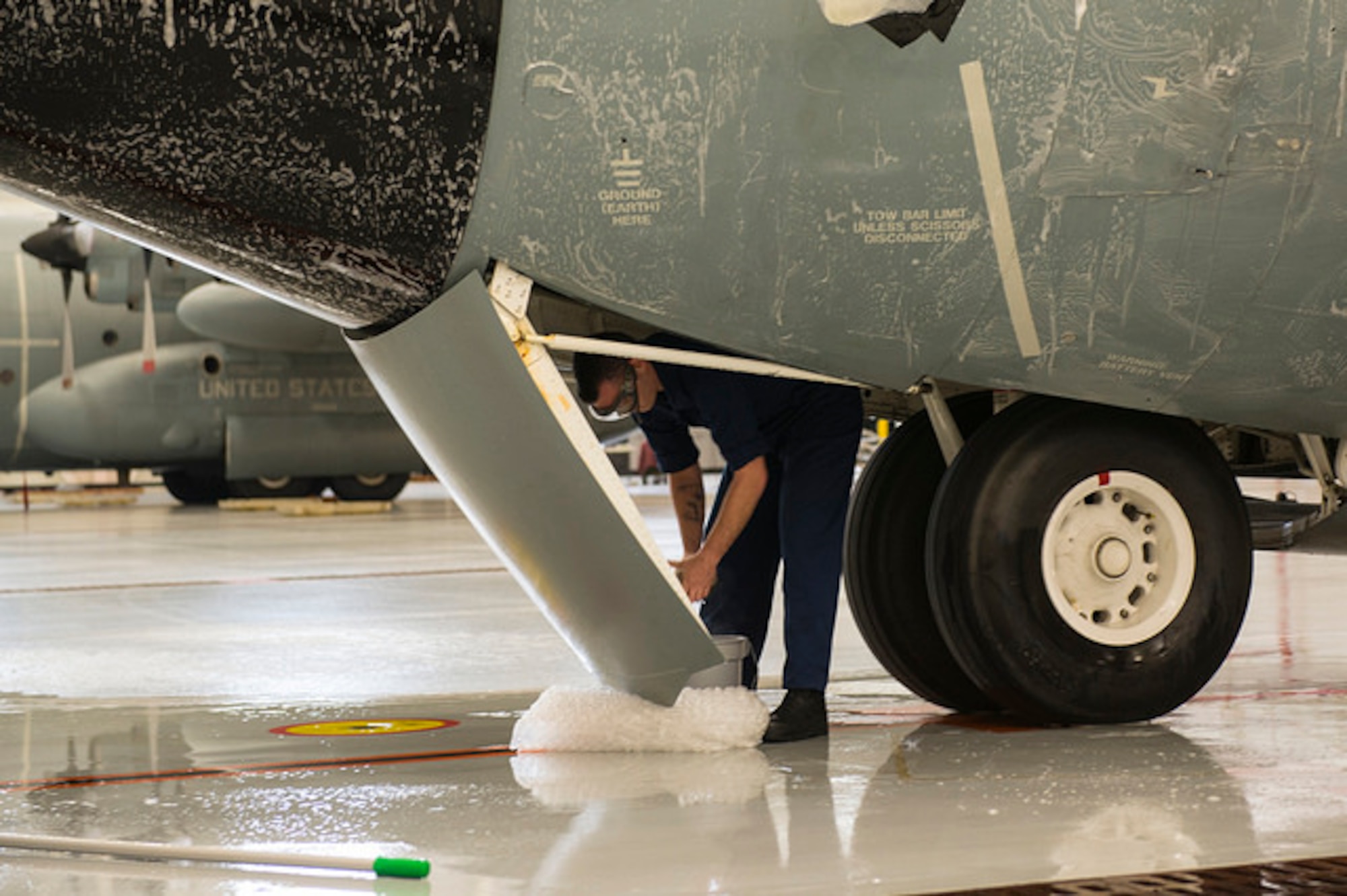 Sailors from Fleet Logistics Support Squadron 64 scrub the exterior of a C-130 Hercules on Joint Base McGuire-Dix-Lakehurst, N.J. Dec. 9. The Sailors wash each of their 5 C-130's every 105 days to protect from corrosion. 