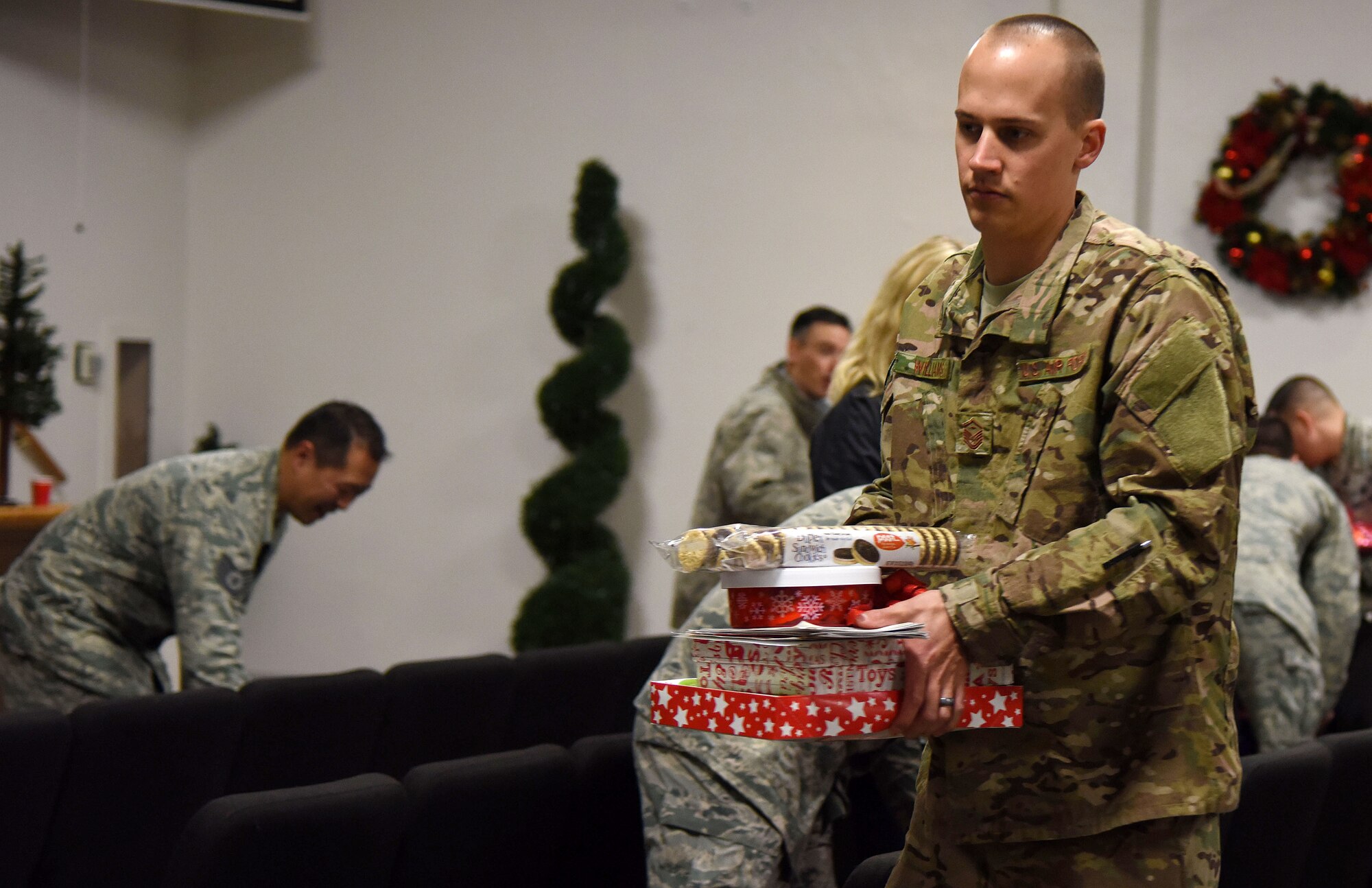 Master Sgt. Lincoln Williams, 22nd Special Tactics Squadron first sergeant, prepares to deliver cookies during Operation Cookie Drop Dec. 10, 2015 at McChord Field, Wash. Williams along with other McChord First Sergeants delivered more the 500 boxes of cookies to Airmen in the dorms in effort to spread holiday cheer. (U.S. Air Force photo/Staff Sgt. Katie Jackson)