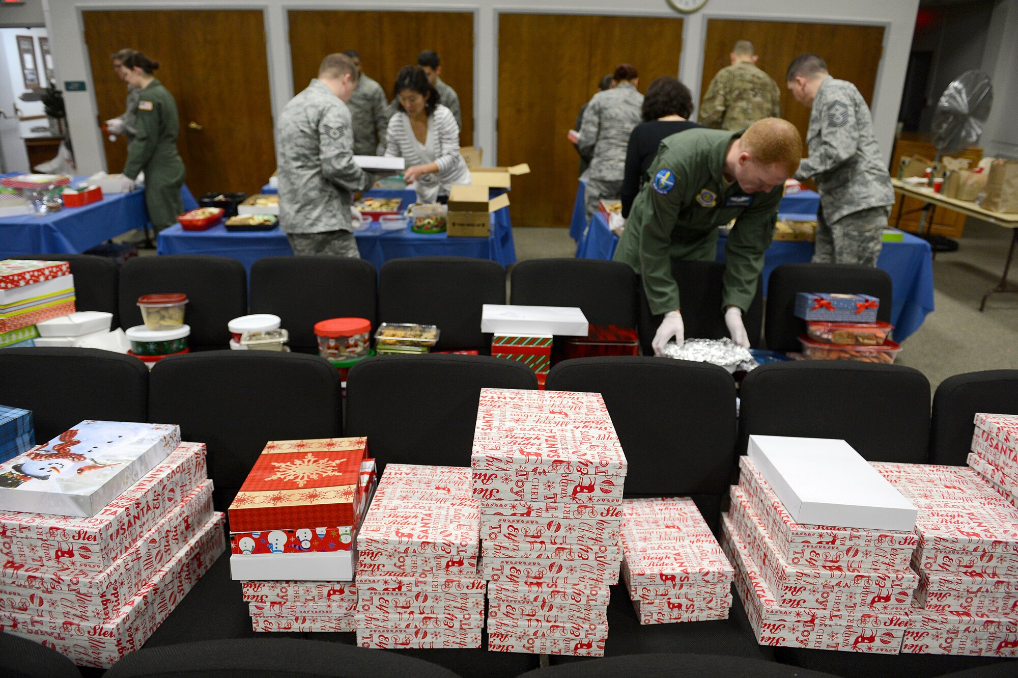 Team McChord volunteers fill boxes with cookies during Operation Cookie Drop Dec. 9, 2015 at McChord Field, Wash. The volunteers assisted with collecting and boxing cookies that were later delivered to Airmen living in the dorms. (U.S. Air Force photo/Senior Airman Divine Cox)