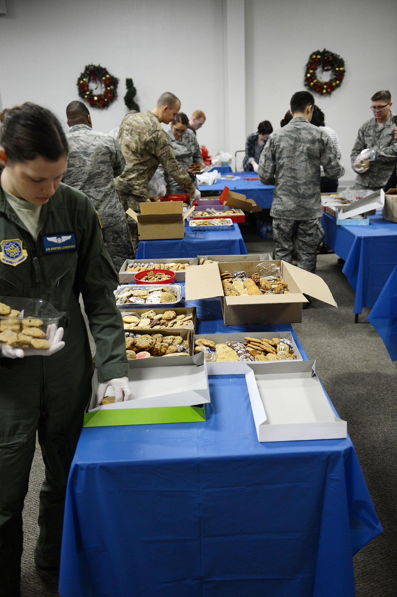 Team McChord volunteers fill boxes with cookies during Operation Cookie Drop Dec. 9, 2015 at McChord Field, Wash. The volunteers assisted with collecting and boxing cookies that were later delivered to Airmen living in the dorms. (U.S. Air Force photo/Senior Airman Divine Cox)