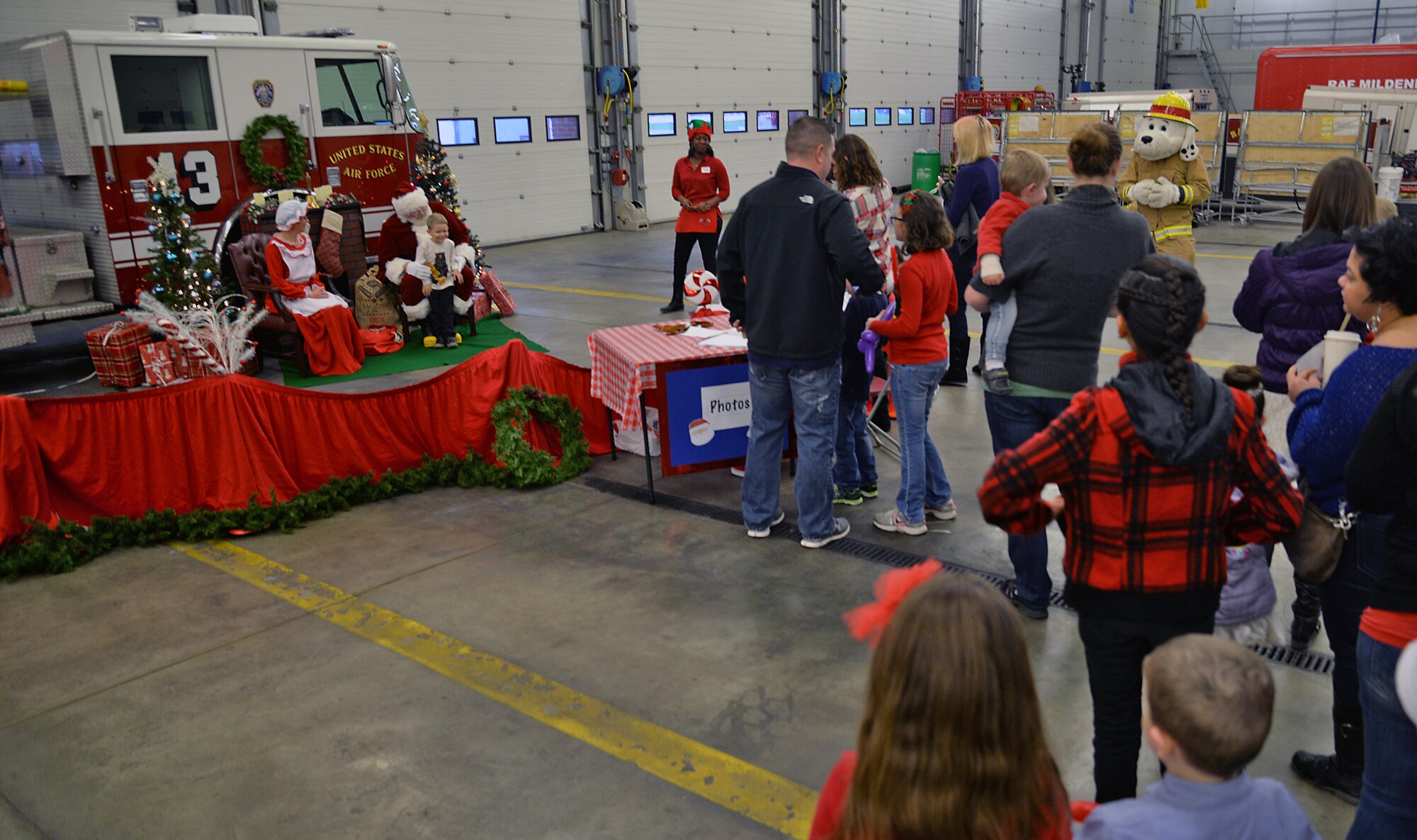 Santa and Mrs. Claus take photos with Team Mildenhall children Dec. 12, 2015, during the monthly Hearts Apart event on RAF Mildenhall, England. Hearts Apart is held monthly for all families of deployed Airmen and is hosted by units to show appreciation for the families and offer support during the Airmen’s absence. (U.S. Air Force photo by Senior Airman Christine Halan/Released)