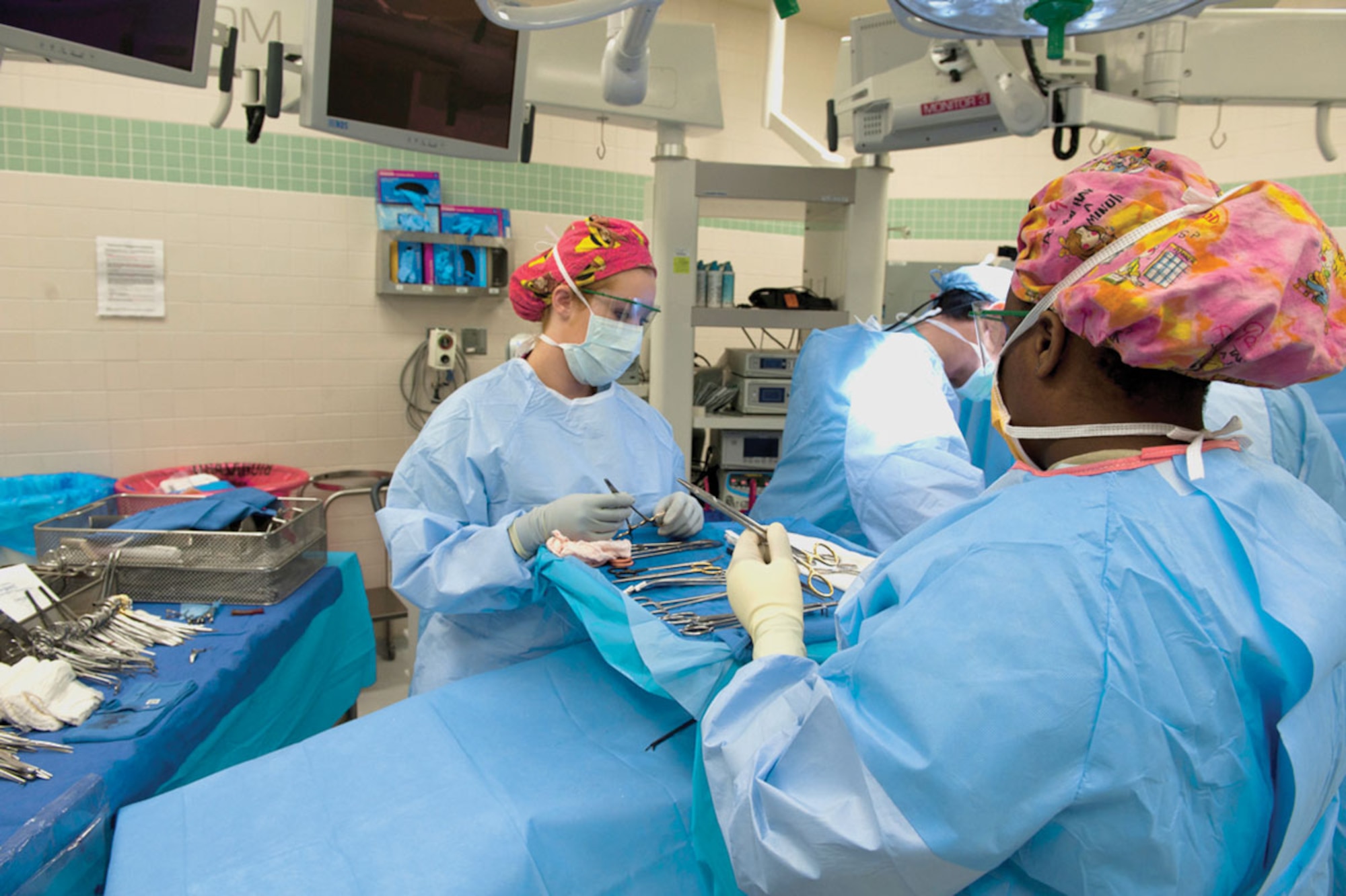 Surgical technicians with the 673d Medical Support Squadron work in an operating room of the JBER hospital.  (U.S. Air Force Photo/ Airman 1st Class Omari Bernard)