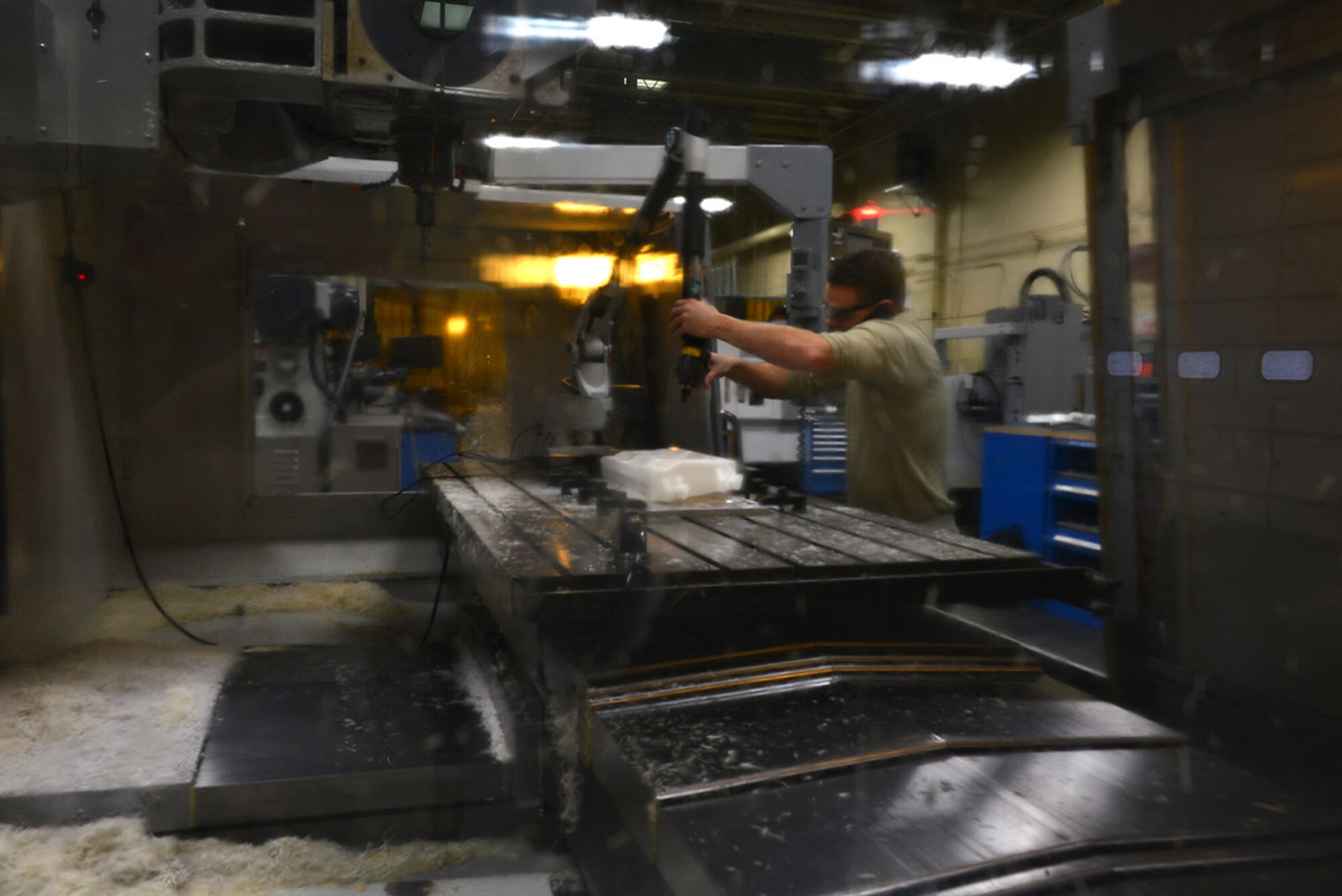 Air Force Staff Sgt. Jeremy Hamblin, 3rd Maintenance Squadron, Aircraft Metals Technology Flight craftsman uses a portable coordinate measuring machine to measure the inconsistencies on a plastic mold in the Aircraft Metals Technology building November 24. After measuring the discrepancies, Hamblin can plug the data into the system to ensure they are not replicated on the aluminum billet. (U.S. Air Force photo by Airman 1st Class Kyle Johnson)