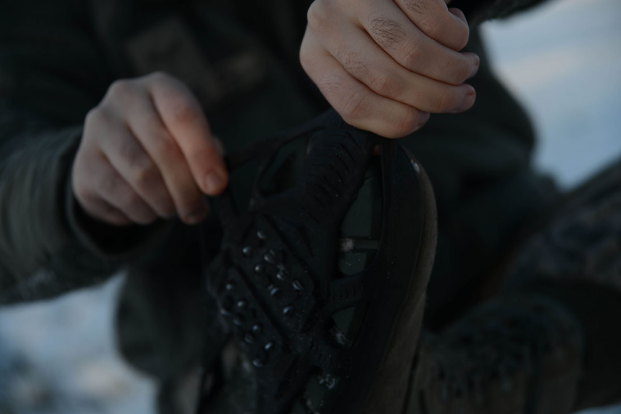 Airman 1st Class Christopher R. Morales, 673d Air Base Wing Public Affairs photojournalist, at Joint Base Elmendorf-Richardson, Alaska, prepares to walk down an icy path, Dec. 10, 2015. The use of ice cleats can prevent slips on the ice. (U.S. Air Force photo by Airman 1st Class Javier Alvarez)