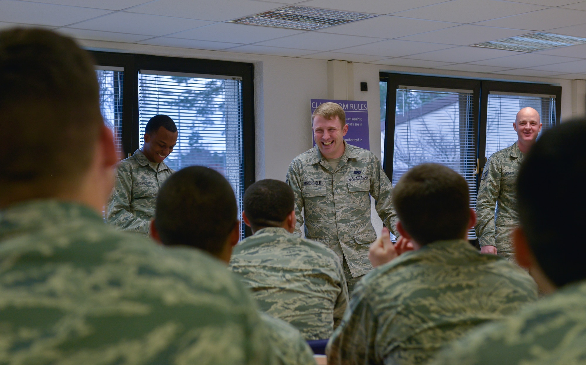 Senior Airman John Burchfield, 86th Force Support Squadron First Term Airman’s Center lead, shares a laugh while heading a class activity to learn about each other Dec. 14, 2015, at Ramstein Air Base, Germany. According to Burchfield, the goal of being an FTAC lead is to serve as an early role model for new Airmen. (U.S. Air Force photo/Airman 1st Class Lane T. Plummer)