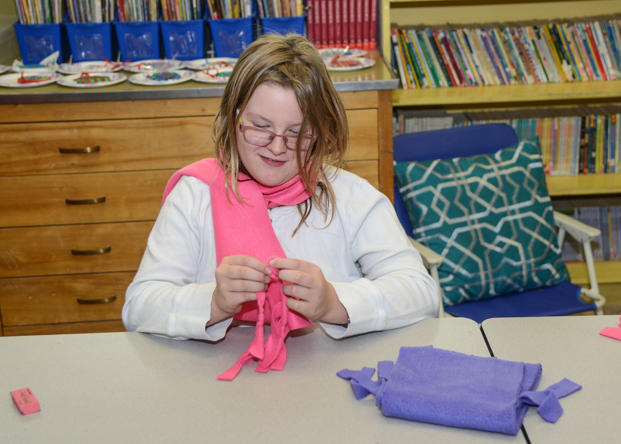 Fourth grade students in Elizabeth Davis’ class at Branch Elementary School decorated Christmas cards and tied the fringe in fleece scarves to donate to the homeless this holiday season. (U.S. Air Force photo by Rebecca Amber)