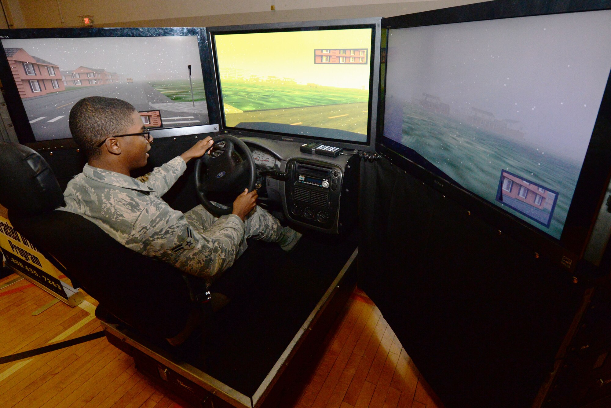 U.S. Air Force Airman 1st Class Brandon Horton, 88th Security Forces Squadron entry controller, drives a simulator that demonstrates what it’s like to drive drunk during the Save a Life Tour presentation inside the Jarvis Fitness Center at Wright-Patterson Air Force Base, Ohio, Dec. 10, 2015. The simulator has a built in delay on the steering wheel, gas and brake pedals that mimic what the Airman would feel had he actually been driving drunk. (U.S. Air Force photo / Wesley Farnsworth/Released)
