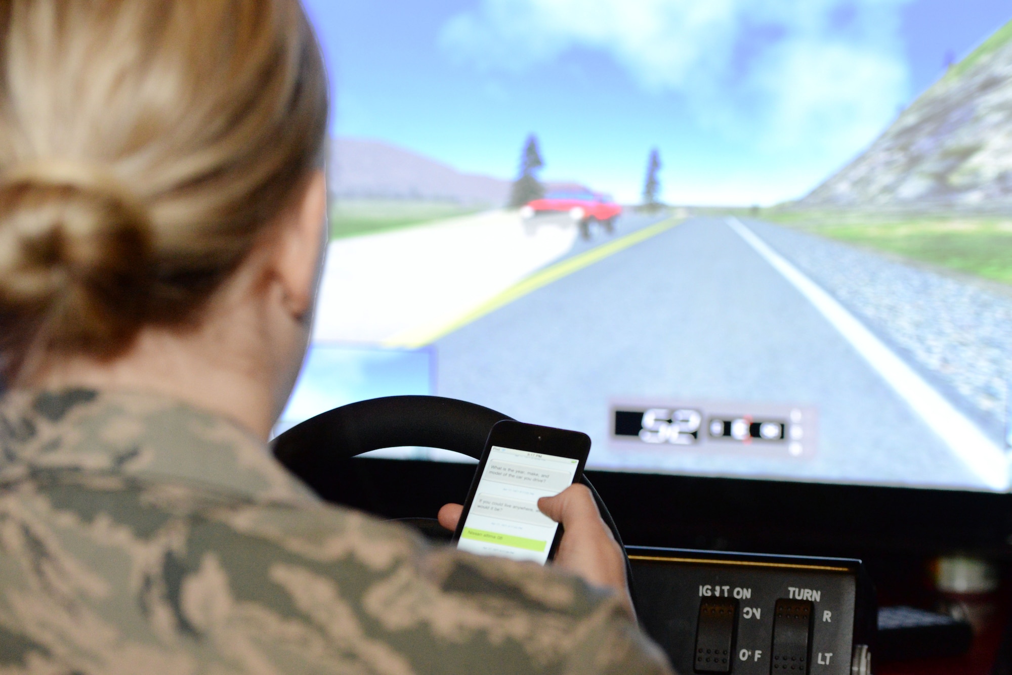 U.S. Air Force Senior Airman Whitney Kennard, 88th Security Forces Squadron entry controller, replies to a text while driving a simulator during the Save a Life Tour presentation inside the Jarvis Fitness Center at Wright-Patterson Air Force Base, Ohio, Dec. 10, 2015. The simulator shows the driving how hard it is to control the car, follow all the rules of the road all while texting and how dangerous it is. (U.S. Air Force photo / Wesley Farnsworth/Released)