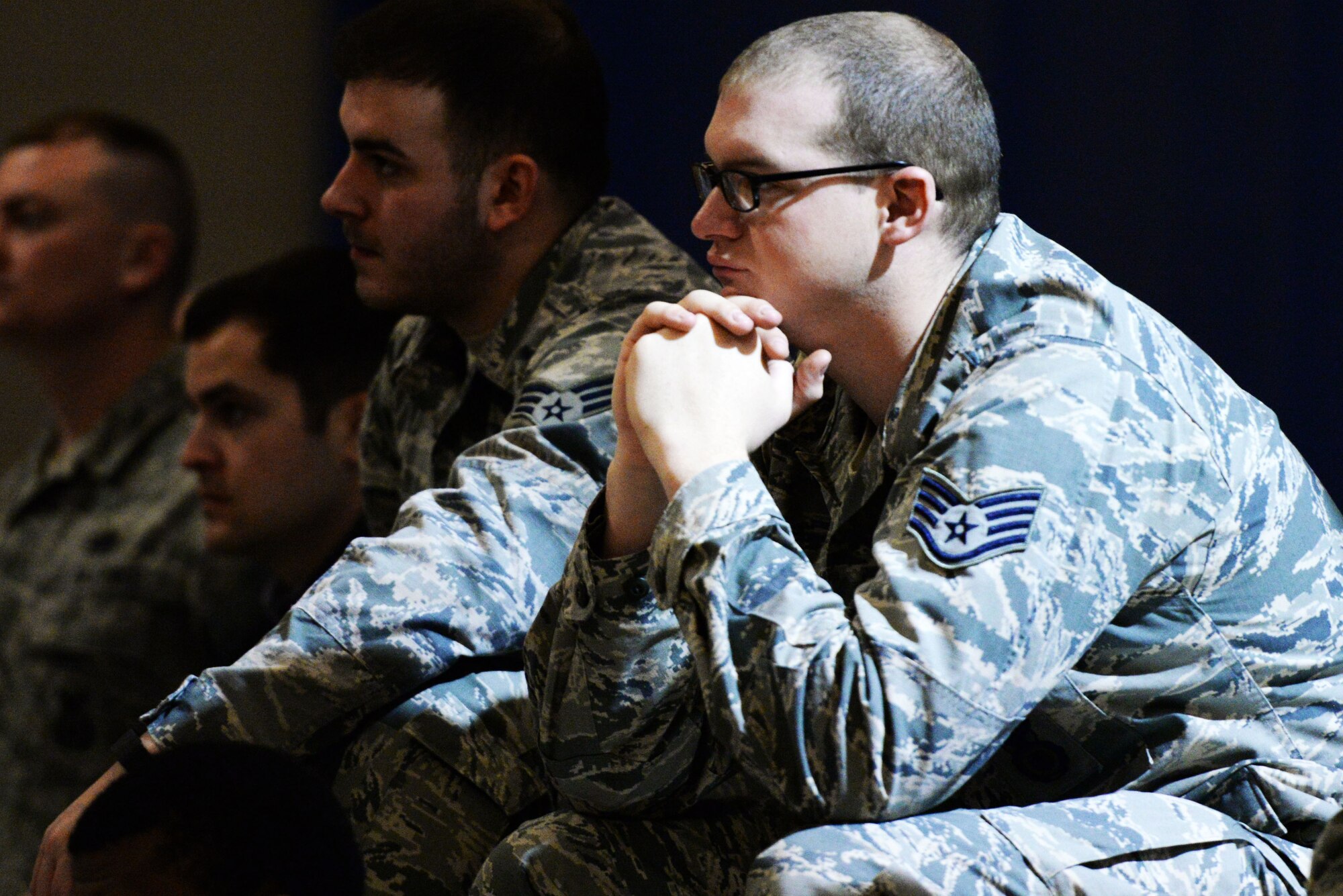 U.S. Air Force Staff Sgt. Thaddeus Mooney, 88th Security Forces Squadron patrolman, listens to the Save a Life Tour presentation inside the Jarvis Fitness Center at Wright-Patterson Air Force Base, Ohio, Dec. 10, 2015. The presentation talked about the dangers and impact of driving while distracted by texting, drinking and driving, or even simply eating a cheese burger. (U.S. Air Force photo / Wesley Farnsworth/Released)