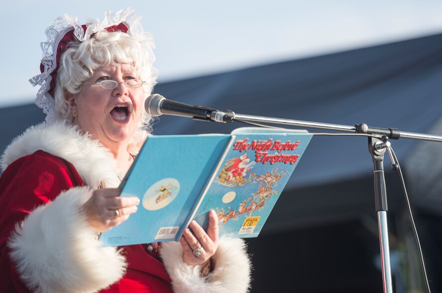 Belinda Pugh, Kadena Air Base librarian, reads The Night Before Christmas Dec. 12, 2015, during tinsel town at Kadena Air Base, Japan. The 18th Force Support Squadron coordinates and organizes Tinsel Town to build morale for military members, civilians and their families during the holiday season. (U.S. Air Force photo by Senior Airman Omari Bernard)