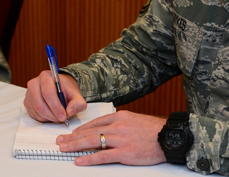 Master Sgt. Clinton Dykes, 2nd Operations Support Squadron tower chief controller, takes notes during a speed mentoring session at Barksdale Air Force Base, La., Dec. 11, 2015. The mentor program began as a way for Airmen to learn from junior NCOs, but has expanded to include senior NCOs and chief master sergeants. (U.S. Air Force photo/Senior Airman Benjamin Raughton)