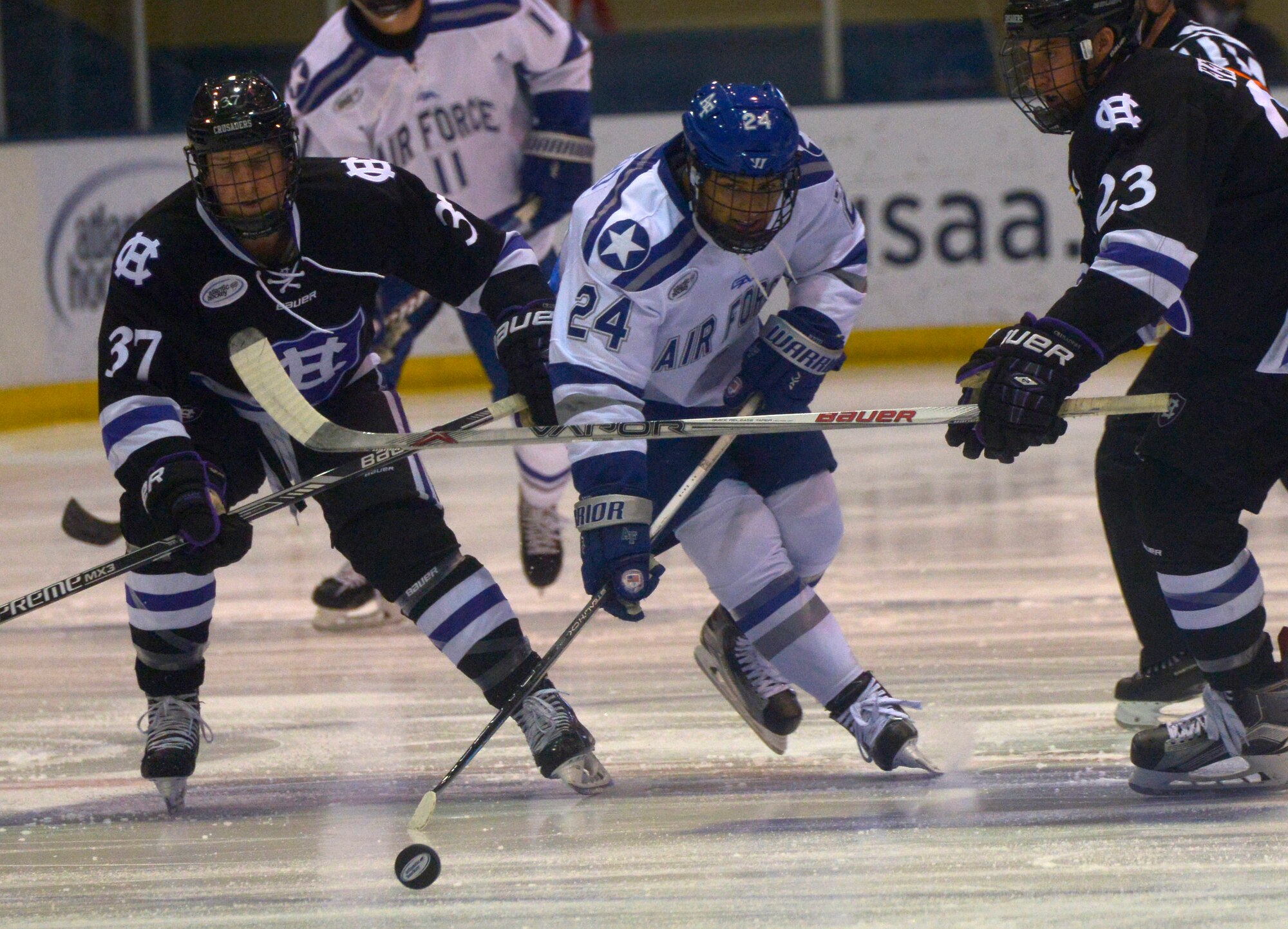 Cadet 2nd Class A.J. Reid, a U.S. Air Force Academy junior, battles for possession of the puck as the Falcons meet foe Holy Cross at the Cadet Ice Arena in Colorado Springs, Colo., Nov. 12, 2015. Holy Cross defeated the Falcons 3-1. (U.S. Air Force photo/Staff Sgt. Christopher Griffin)