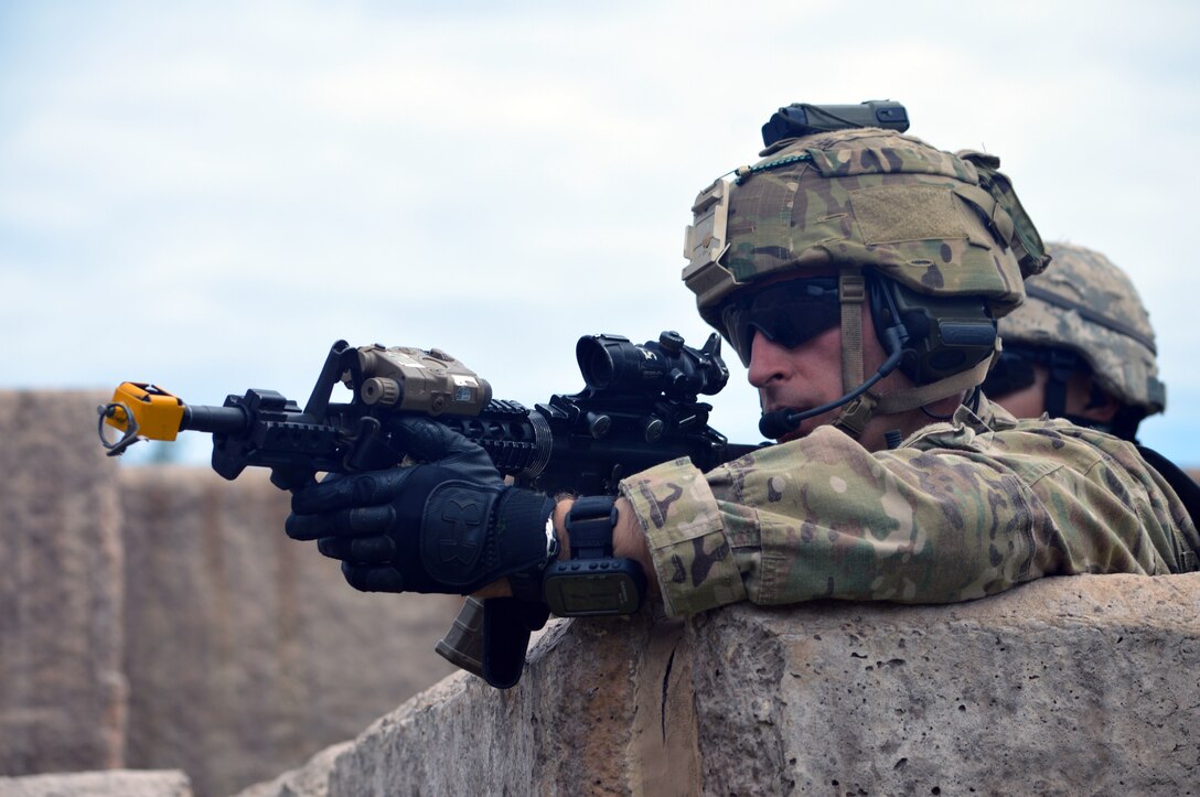 A soldier maintains security position during training on Marine Corps Training Area Bellows, Hawaii, Dec. 2, 2015. U.S. Army photo by Staff Sgt. Armando Limon