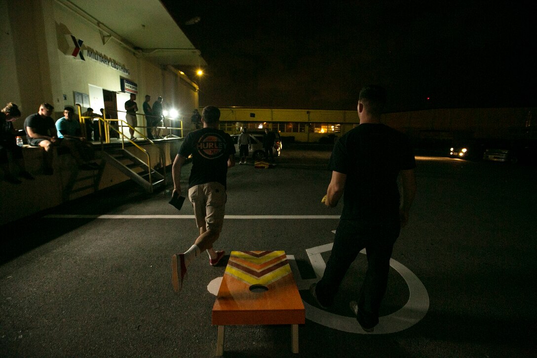 Marines and sailors participate in "cornhole" competitions during Elevate on Camp Foster, Okinawa, Japan, Dec. 11. Elevate is a program created for service members to come together and enjoy an alcohol-free night, as well as to promote healthy behavioral choices. During the program the service members ate, played video games and other activities all leading up to the final event, bubble soccer.  (U.S. Marine Corps photo by Lance Cpl. Jessica N. Etheridge/Released)
