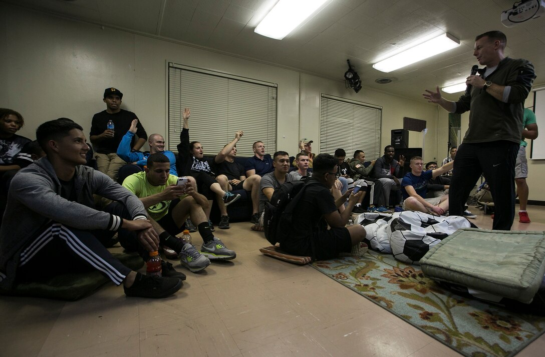 U.S. Navy Lt. Todd A. Trumble speaks to Marines and sailors about Elevate and the upcoming plans Dec. 11 on Camp Foster, Okinawa, Japan. Elevate is a program created for service members to come together and enjoy an alcohol-free night, as well as to promote healthy behavioral choices. Trumble from Lynchburg, Virginia is a chaplain with Marine Wing Support Squadron 172, 1st Marine Aircraft Wing, III Marine Expeditionary Force. (U.S. Marine Corps photo by Lance Cpl. Jessica N. Etheridge/Released)