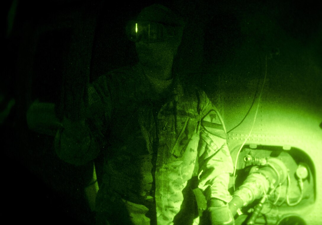 As seen through a night-vision device, U.S. Army Pfc. Brandon Clark refuels a UH-60 Black Hawk helicopter arriving on Mihail Kogălniceanu Air Force Base, Romania, Dec. 9, 2015. Clark is a fueler assigned to the 1st Cavalry Division's 3rd Battalion, 227th Assault Helicopter Battalion, Air Cavalry Brigade. U.S. Army photo by Staff Sgt. Steven M. Colvin