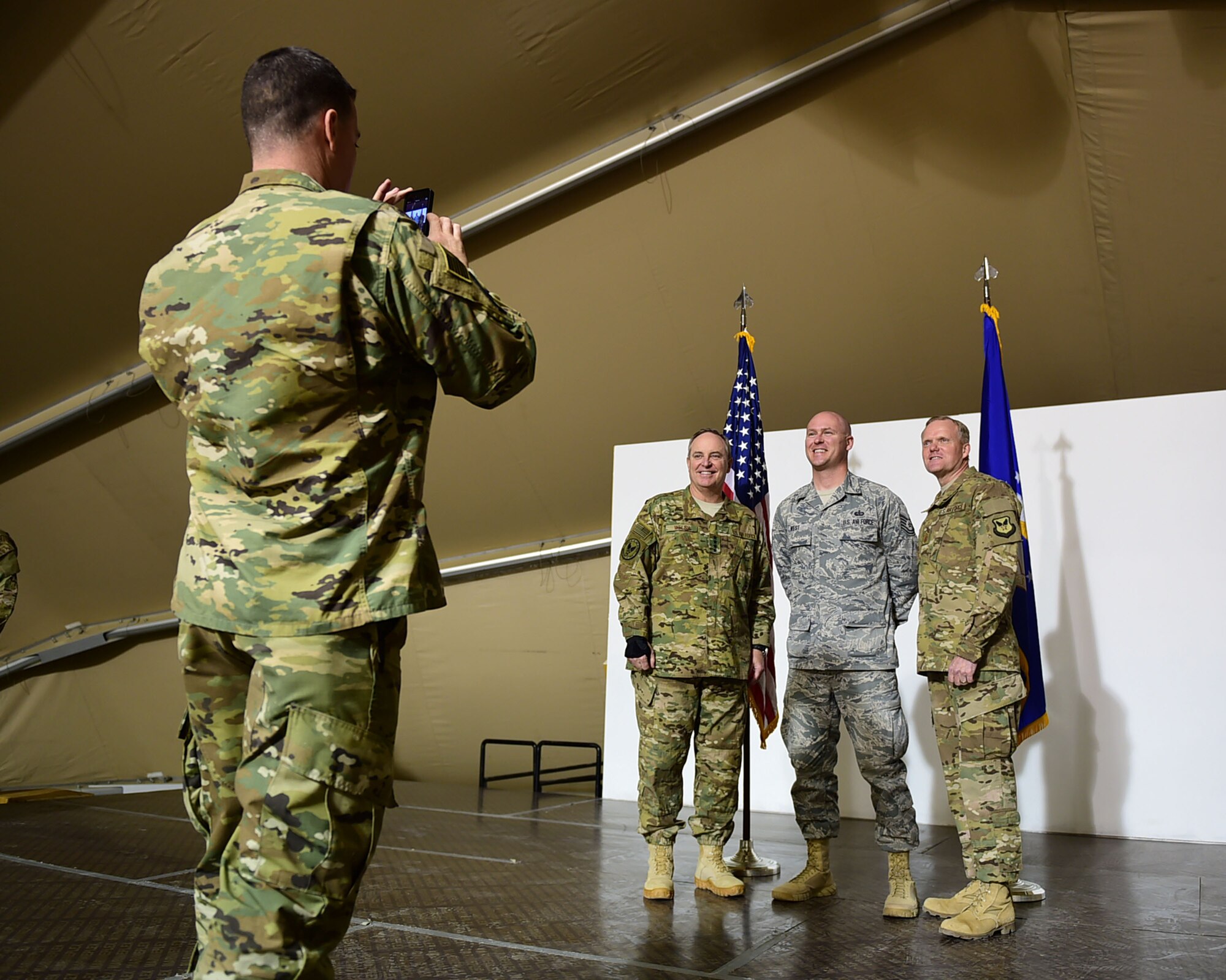 Air Force Chief of Staff Gen. Mark A. Welsh III and Chief Master Sgt. of the Air Force James A. Cody pose for a personal photo with Tech. Sgt. Adam West, from the 332nd Expeditionary Force Support Squadron, during a visit to an undisclosed location in Southwest Asia Dec. 10, 2015. During their visit Welsh and Cody hosted an all-call during which they fielded questions about deployments, manning and sustaining the force. (U.S. Air Force photo by Staff Sgt. Jerilyn Quintanilla)
