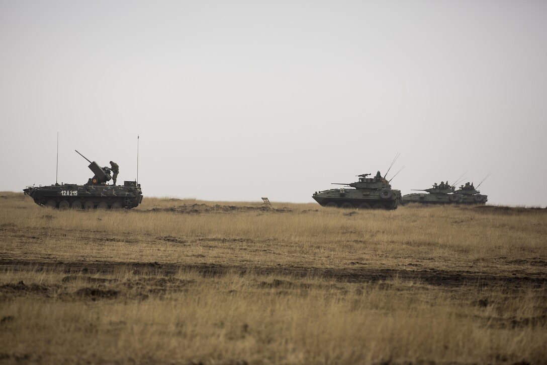 U.S., Romanian, and Moldovan military members participate in a tank shoot rehearsal during Platinum Lynx 16-2 at Smardan Training Area, Romania, Dec. 9, 2015. Exercise Platinum Lynx 16-2 is a NATO-led multinational exercise designed to strengthen combat readiness, increase improve collective capabilities, and maintain proven relationships with allied and partner nations. (U.S. Marine Corps photo by Lance Cpl. Melanye E. Martinez/Released)