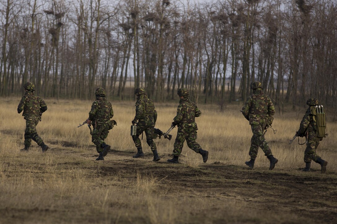 U.S. Marines with Combined Arms Company, Black Sea Rotational Force, conduct field training with Romanian and Moldovan armed forces during Platinum Lynx 16-2 at Smardan Training Area, Romania, Dec. 9, 2015. Exercise Platinum Lynx 16-2 is a NATO-led multinational exercise designed to strengthen combat readiness, increase improve collective capabilities, and maintain proven relationships with allied and partner nations. (U.S. Marine Corps photo by Lance Cpl. Melanye E. Martinez/Released)