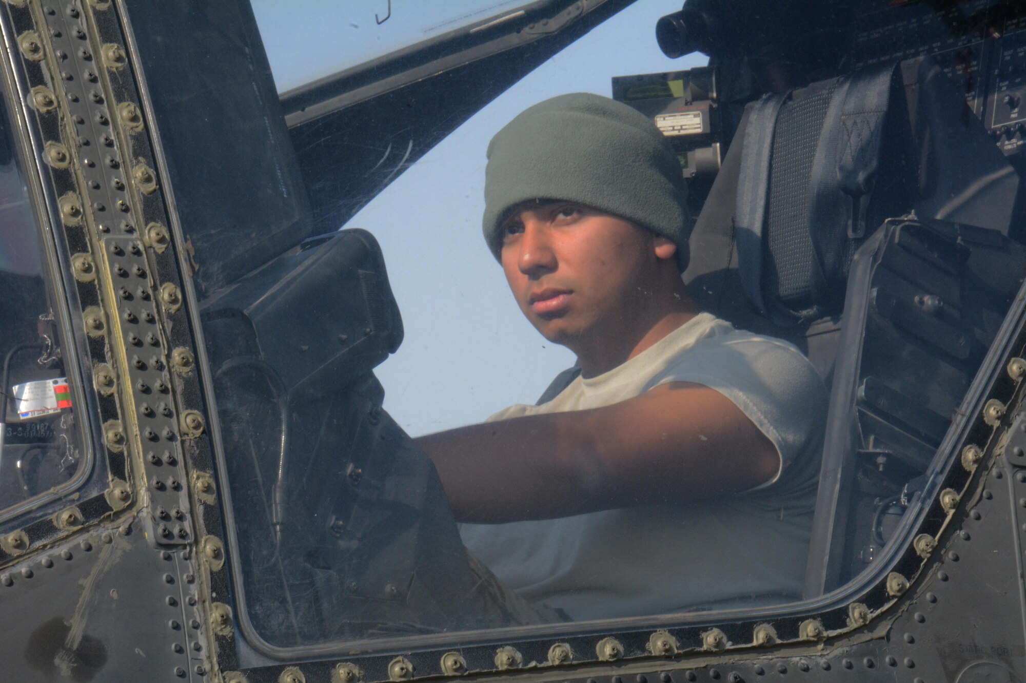 A 3-6 Heavy Cavalry Regiment soldier deployed from Fort Bliss, Texas sits inside an Apache helicopter at Al Udeid Air Base, Qatar Dec. 13. Two Apache helicopters were delivered to AUAB by a C-17 Globemaster III, which is deployed from the 62nd Airlift Wing at Joint Base Lewis-McChord, Washington. The helicopters are scheduled to take part in the annual Qatar National Day Parade set for Dec. 18. (U.S. Air Force photo by Tech. Sgt. James Hodgman/Released)