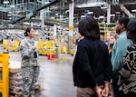 Students from Central York High School talk about real-world logistics inside the Eastern Distribution Center at DLA Distribution Susquehanna, Pa., with Army Chief Warrant Officer 4 Brenda Johnson on Dec. 10. 