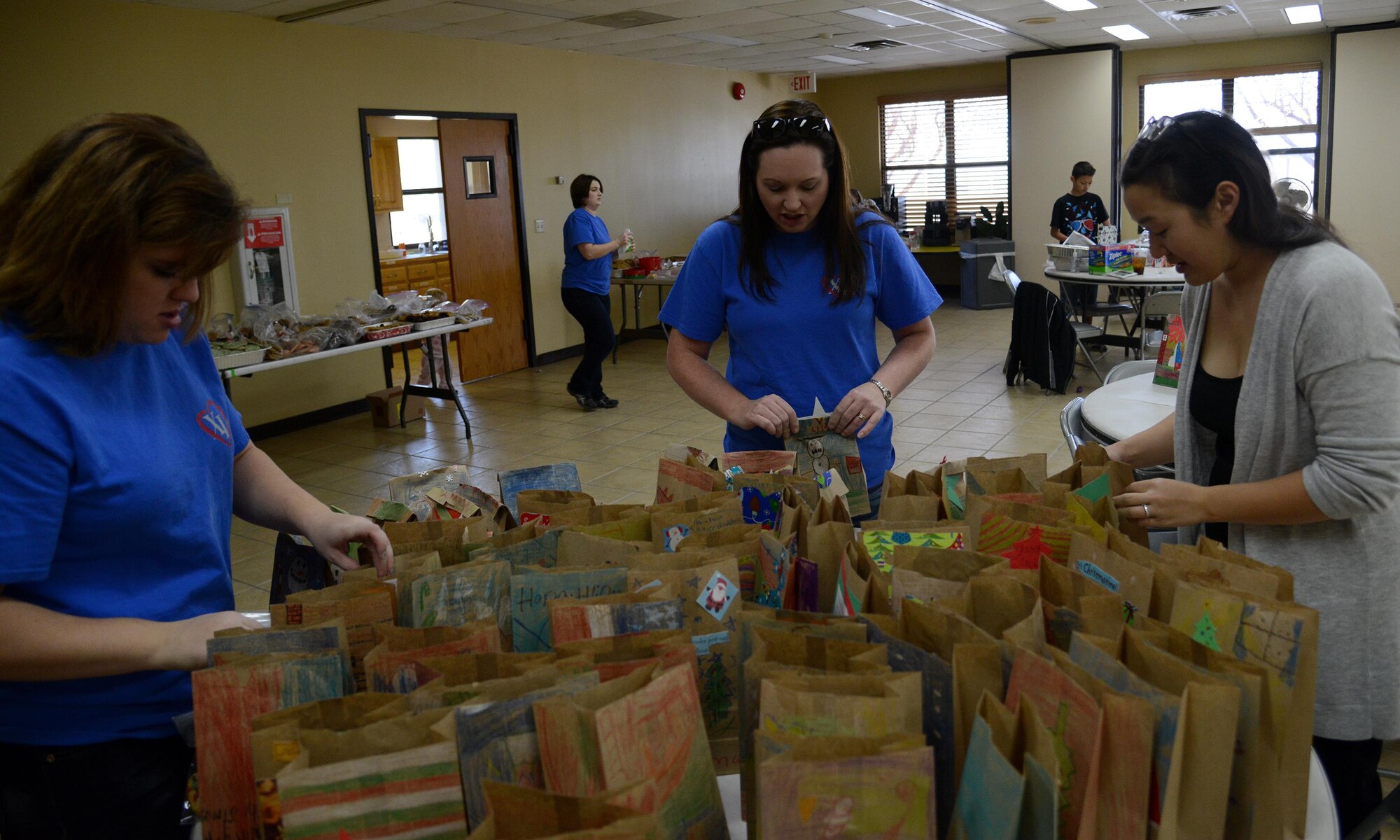Laughlin spouses prepare cookie bags at the chapel on Laughlin Air Force Base, Texas, Dec. 10, 2015. About 400 dozen cookies were brought by spouses to bag and deliver to Laughlin’s single Airmen. (U.S. Air Force photo by Airman 1st Class Ariel D. Partlow)
