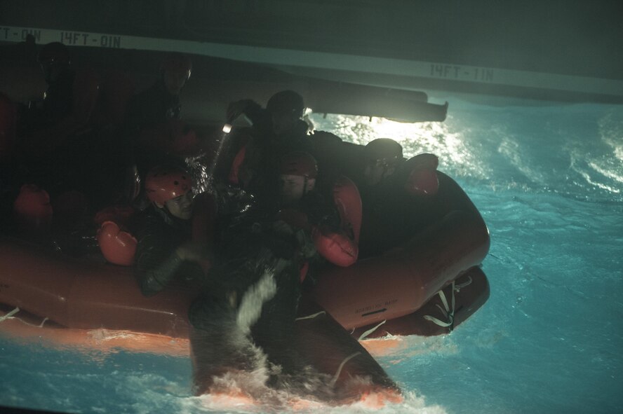 Water Survival students help each other into a life raft during a scenario Dec. 8, 2015, at Fairchild Air Force Base, Wash. The Water Survival Course is two days long and consists of two parts: parachuting and non-parachuting. (U.S. Air Force photo/Airman 1st Class Sean Campbell)