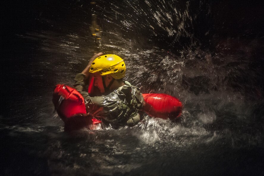 A Water Survival student braves the turbulent waters before getting hoisted into the fuselage during a training scenario Dec. 8, 2015, at Fairchild Air Force Base, Wash. The survival gear available to Airmen depends on what aircraft they are flying in and under what command the aircraft is flying. Different commands pack different items, but as a standard, aircraft have a raft, raft canopy, canopy poles, rations, medical supplies, radio, signaling devices and a form of water or a way of procuring fresh water. (U.S. Air Force photo/Airman 1st Class Sean Campbell)