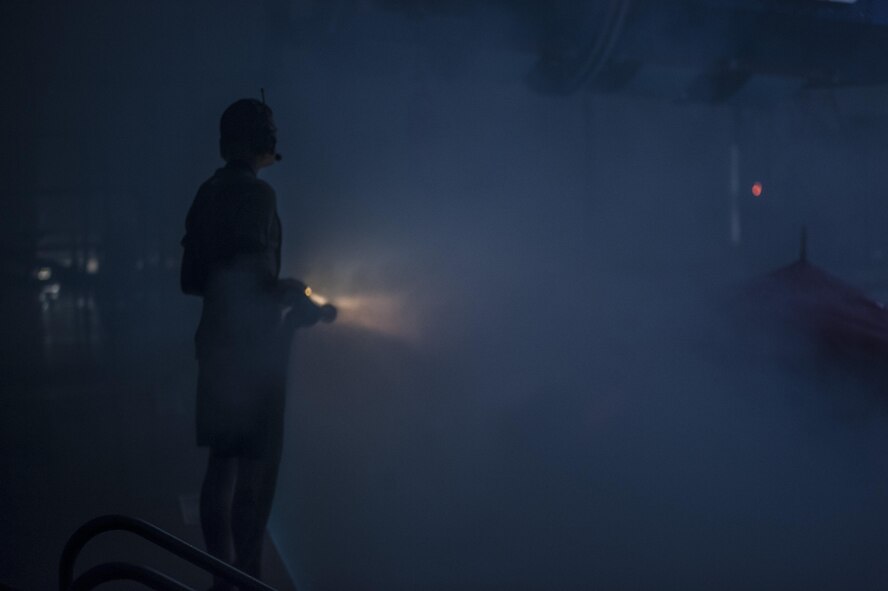 A Survival, Evasion, Resistance and Escape instructor sprays students with water during a training scenario Dec. 8, 2015, at Fairchild Air Force Base, Wash. For the “dunker” portion of the course, S.E.R.E specialists are certified through the Navy Salvage Dive because Water Survival students will be breathing on compressed air in the form of a Helicopter Emergency Egress Device bottle. (U.S. Air Force photo/Airman 1st Class Sean Campbell)