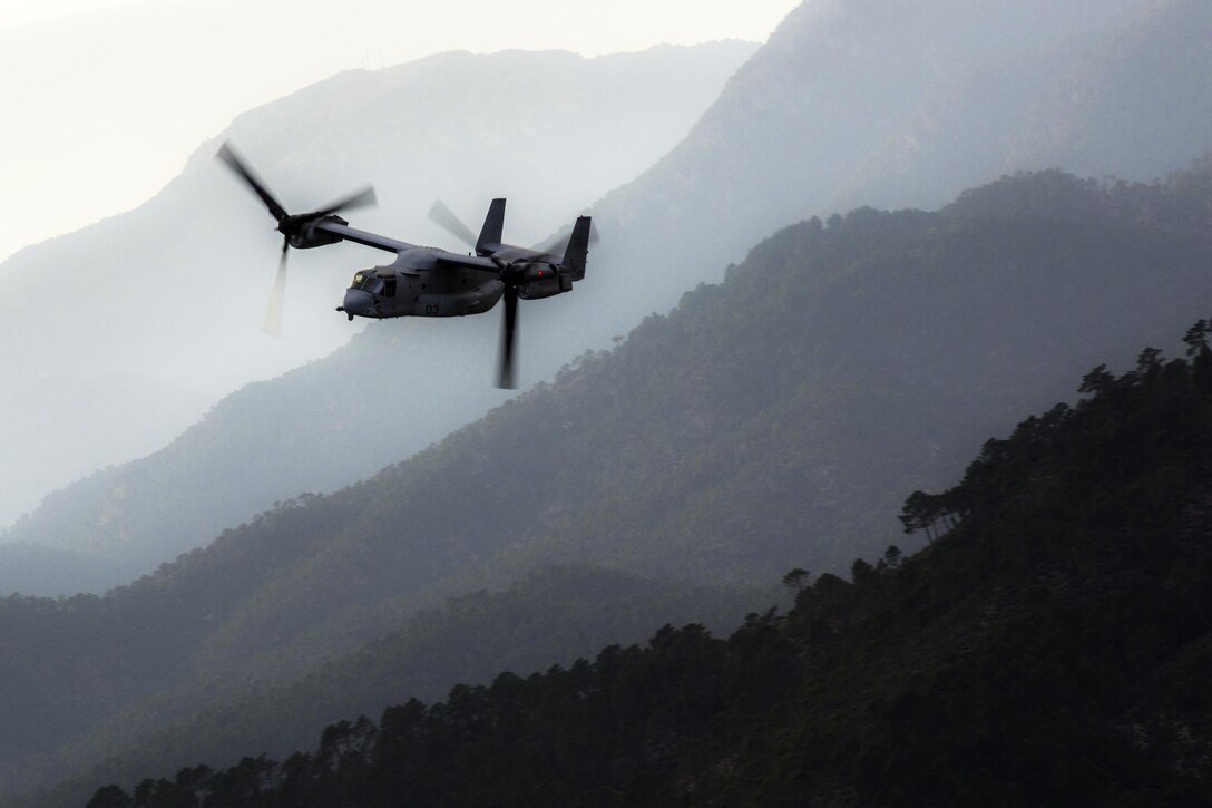 A U.S. Marine Corps MV-22B Osprey travels over mountainous terrain during a tactical recovery of aircraft and personnel exercise near Albacete, Spain, Dec. 7, 2015. The exercise is part of a monthlong training curriculum hosted by the Tactical Leadership Program, a collaboration of 10 NATO nations tasked with training future flight commanders. The Osprey team is with Special Purpose Marine Air-Ground Task Force Crisis Response-Africa. U.S. Marine Corps photo by Staff Sgt. Vitaliy Rusavskiy
