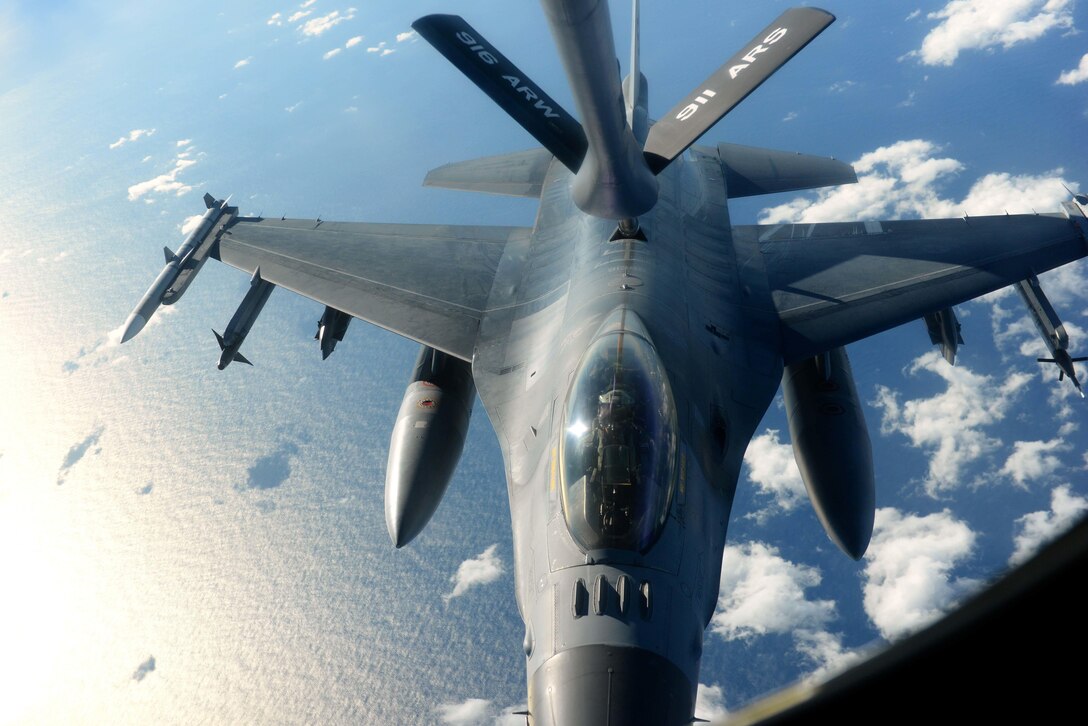 An Air Force F-16 Fighting Falcon receives fuel from a KC-135R Stratotanker over the coast of North Carolina during Exercise Razor Talon, Dec. 14, 2015. U.S. Air Force photo by Senior Airman John Nieves Camacho
