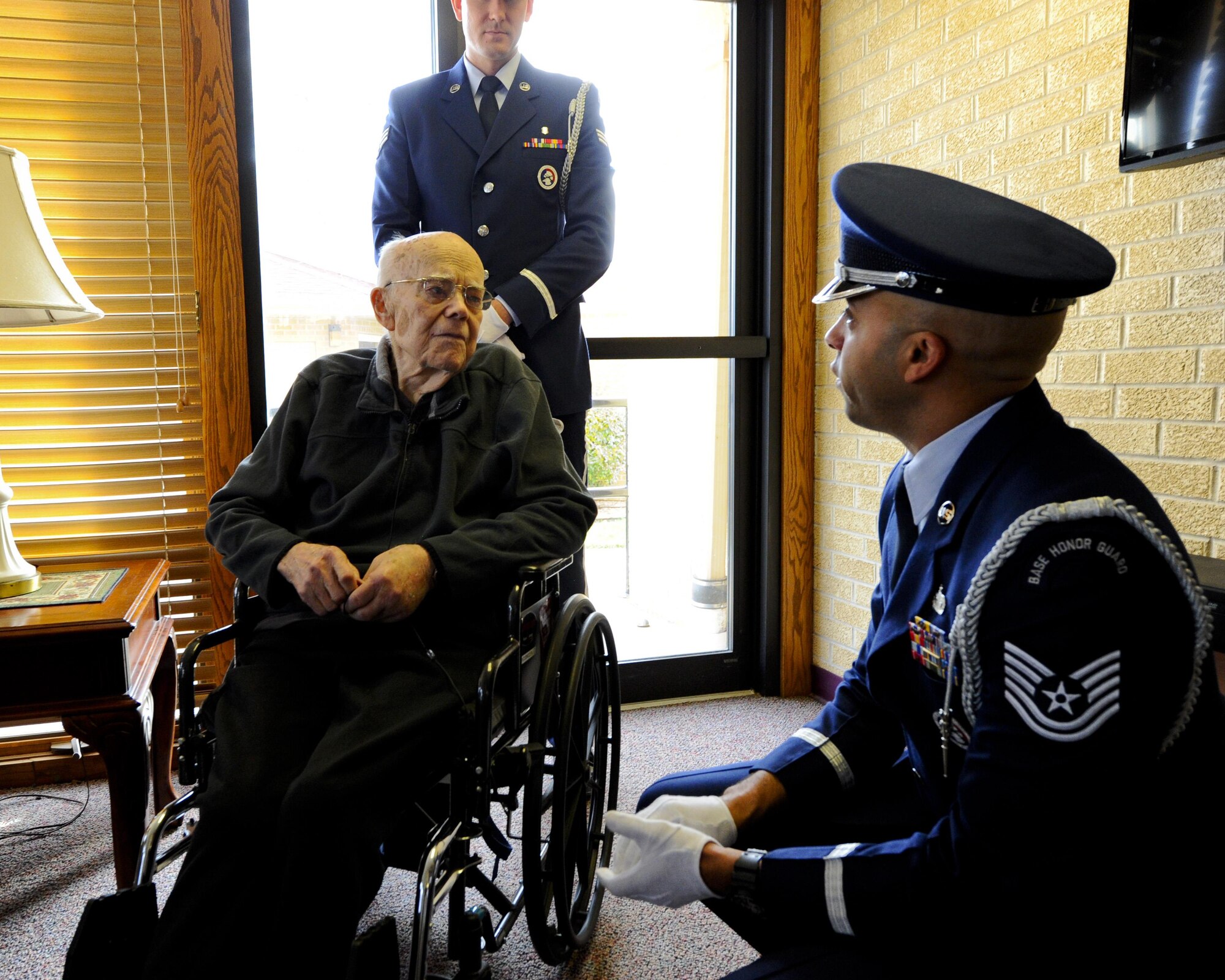 Roy Mullinax, a World War II Army veteran, speaks with Tech. Sgt. Terrance Williams, the 22nd Air Refueling Wing Honor Guard NCO in charge, during a recognition ceremony Dec. 8, 2015, in Newton, Kan. Mullinax enlisted in the Air Force shortly after the end of World War II, and his years of military service led to his recognition with a veteran’s pin through his hospice center. (U.S. Air Force photo/Senior Airman Victor J. Caputo)