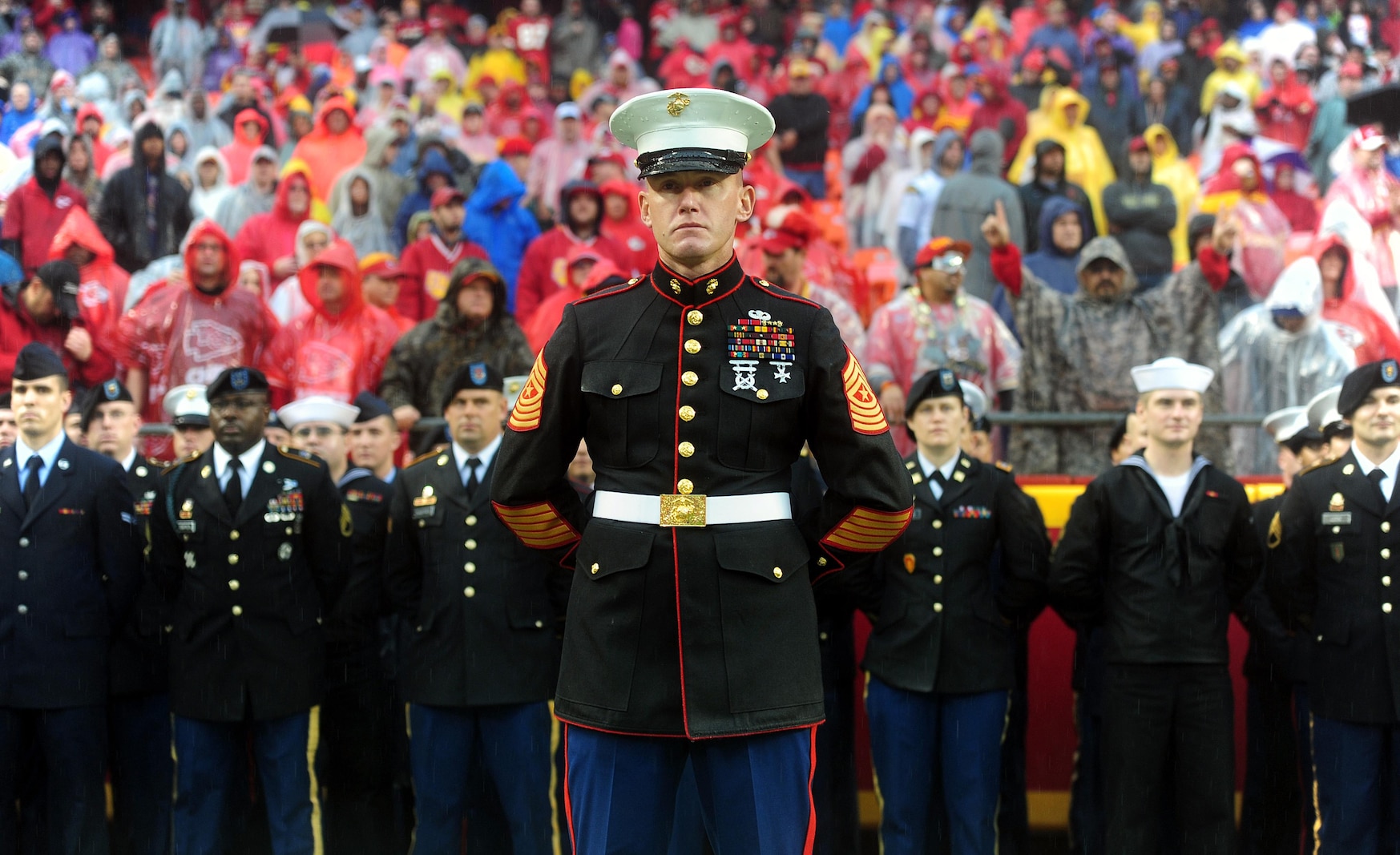 Sergeant Major Christopher A. Farrell, Marine Corps Recruiting Station Kansas City sergeant major, stands before a joint-service formation before the start of the Kansas City Chiefs' Military Appreciation Day game against the San Diego Chargers at Arrowhead Stadium, Dec. 13, 2015. Servicemembers from the Marine Corps, Army, Navy, Air Force, and Coast Guard were in attendance for the day's pregame and halftime festivities which included military vehicle static displays, joint-service color guard, and the Marine Corps Silent Drill Platoon.