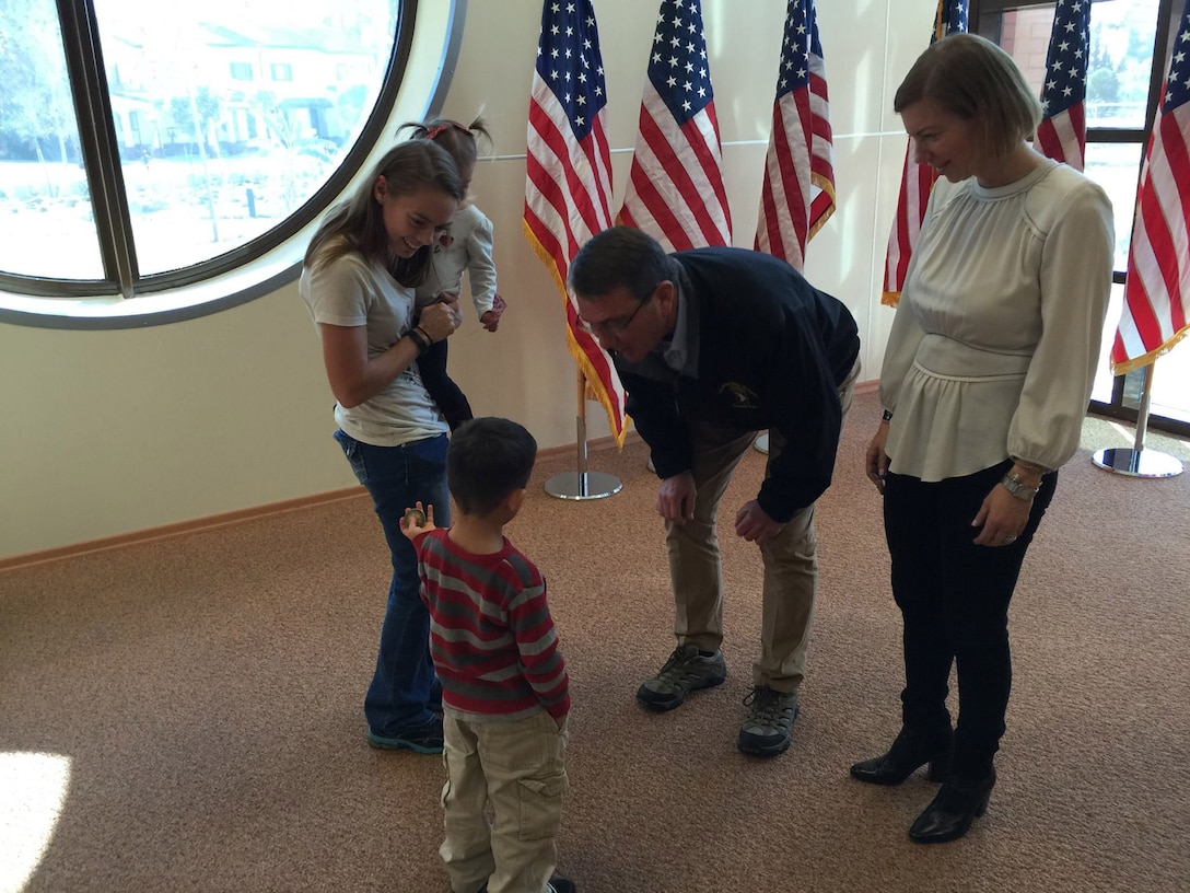 U.S. Defense Secretary Ash Carter talks with a child on Incirlik Air Base, Turkey, Dec. 15, 2015. DoD photo.