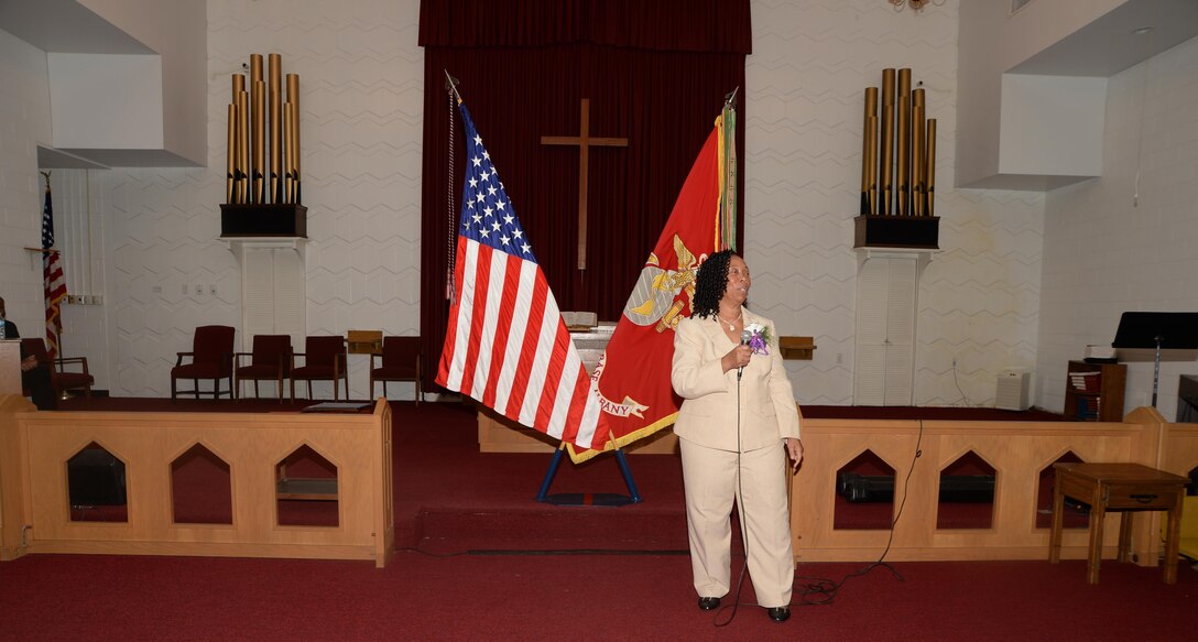 Virginia Williams, IT supervisor, Marine Corps Logistics Base Albany, speaks to the audience during her retirement ceremony, Dec. 10, in the base’s Chapel of the Good Shepherd.