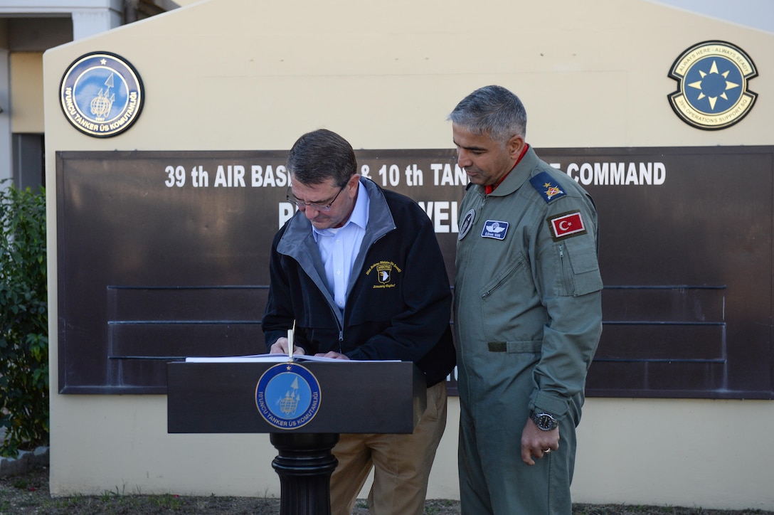 U.S. Defense Secretary Ash Carter signs a guest book as Brig. Gen. Bekir Ercan Van, commander of the 10th Tanker Base Command, stands next to him on Incirlik Air Base, Turkey, Dec.15, 2015. DoD photo by Army Sgt. 1st Class Clydell Kinchen