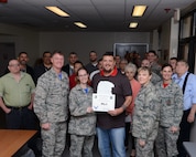 Justin Westbrook, center-right, 47th Civil Engineer Squadron Information Technology specialist, and his wife, Tech. Sgt. Westbrook, center-left, 47th Flying Training Wing commander support staff, pose with Col. Thomas Shank, left, 47th FTW commander, and Chief Master Sgt. Teresa Clapper, 47th FTW command chief, after accepting the “XLer of the Week” award, here, Dec. 11, 2015. The XLer is a weekly award chosen by wing leadership and is presented to those who consistently make outstanding contributions to their unit and Laughlin. (U.S. Air Force photo by Senior Airman Jimmie D. Pike)