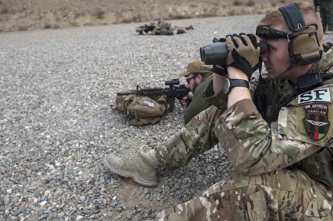 U.S. Air Force Capt. Ryan Kiggins, right, views targets at a firing range near Kabul, Afghanistan, Dec. 8, 2015. Kiggens is assigned to the security forces with Train, Advise, Assist Command-Air. U.S. Air Force photo by Staff Sgt. Corey Hook