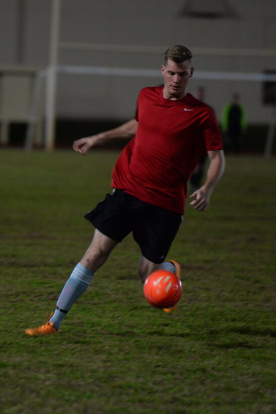 Senior Airman Michael Page, 36th Expeditionary Aircraft Maintenance Squadron, takes a shot at the ball during the intramural soccer championship Dec. 14, 2015, at Andersen Air Force Base, Guam. The 36th EAMXS Bomber Barons defeated the 36th Air Mobility Squadron Eagles after a harrowing game with a score of 3-2. (U.S. Air Force Photo/Airman 1st Class Alexa Ann Henderson)