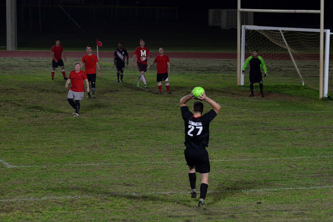 Senior Airman David Lemon, 36th Air Mobility Squadron, throws in the soccer ball during the intramural soccer championship Dec. 14, 2015, at Andersen Air Force Base, Guam. Since the beginning of the season in November, the 36th Expeditionary Aircraft Maintenance Squadron beat out seven other teams to reach the championship game. (U.S. Air Force photo/Airman 1st Class Alexa Ann Henderson)