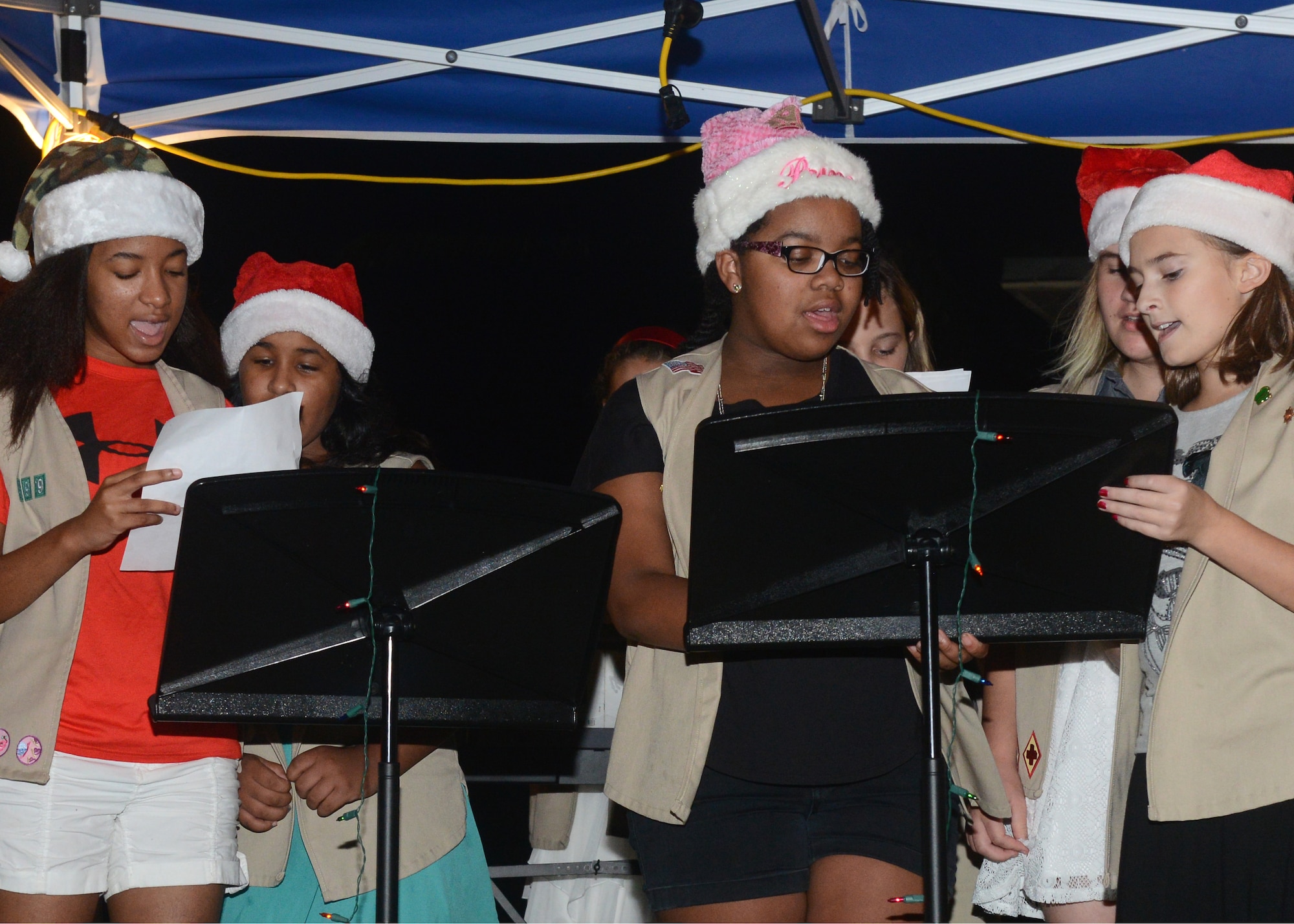 Girl Scouts sing holiday tunes for Team Andersen during the annual base Rota Walk Dec. 12, 2015, at Andersen Air Force Base, Guam. Hundreds of military members and civilians attended the event which is held every December to showcase holiday decorations in the base housing area on Rota Drive. (U.S. Air Force photo/Airman 1st Class Arielle Vasquez)