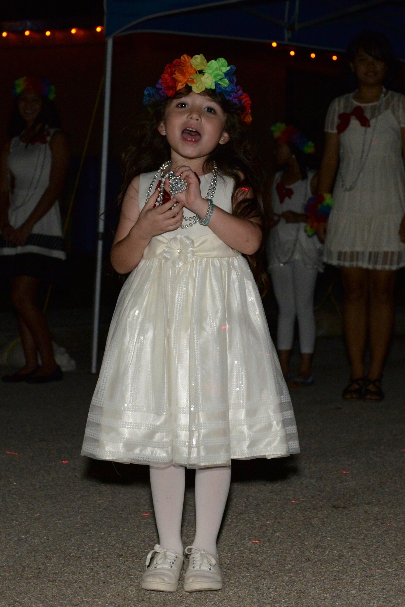 A young girl sings a solo Dec. 12, 2015, during the annual Rota Walk at Andersen Air Force Base, Guam. Rota Walk is an annual family event that showcases Andersen’s holiday spirit. (U.S. Air Force photo/Airman 1st Class Jacob Skovo)