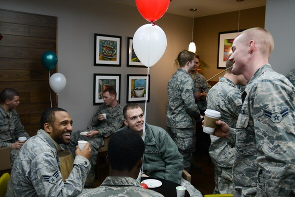 Airmen enjoy coffee during the Mustang Café grand opening at Osan Air Base, Republic of Korea, Dec. 15, 2015. The new café features a dining area for Airmen to socialize and relax. (U.S. Air Force photo/Airman 1st Class Dillian Bamman)