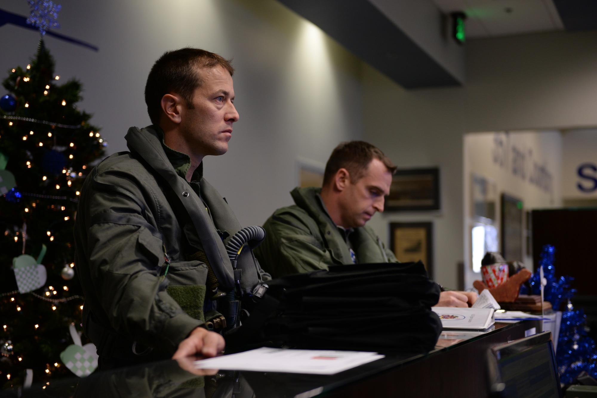 Norwegian Maj. Morten Hanche, 62nd Fighter Squadron F-35 student pilot, listens to his pre-flight brief alongside his sortie wingman and guide, Lt. Col. Gregory Frana, 62nd FS commander, Dec. 14, 2015, at Luke Air Force Base. Hanche has been training with the American pilots of the 62nd FS for the past few months to fly the F-35. (U.S. Air Force photo by Airman 1st Class Ridge Shan)