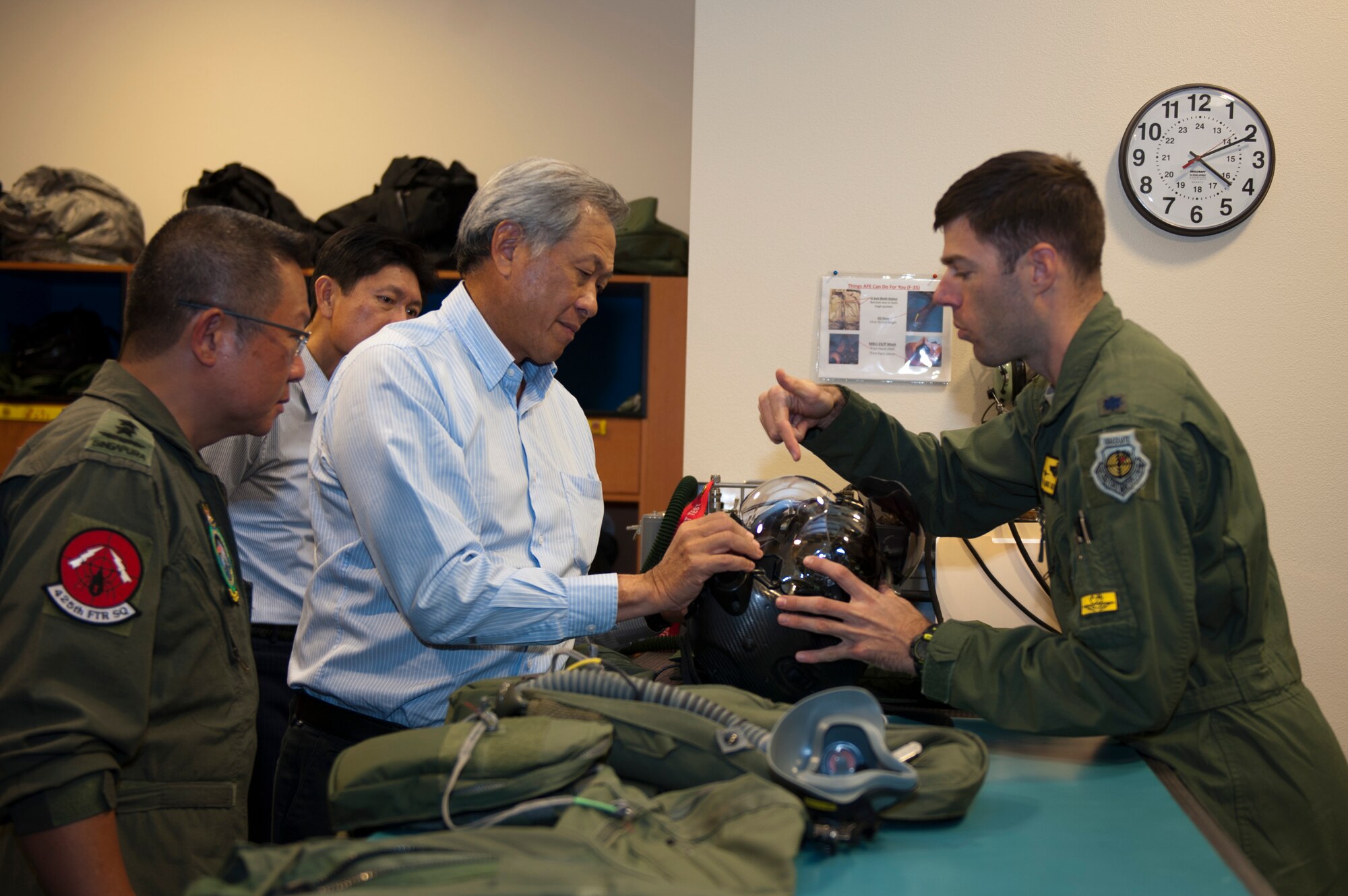 Ng Eng Hen, Singapore defense minister, learns about the F-35 Lightning ll Helmet Mounted Display System during his visit to the 61st Fighter Squadron at Luke Air Force Base, Ariz., Dec. 10, 2015. (U.S. Air Force photo by Staff Sgt. Staci Miller)