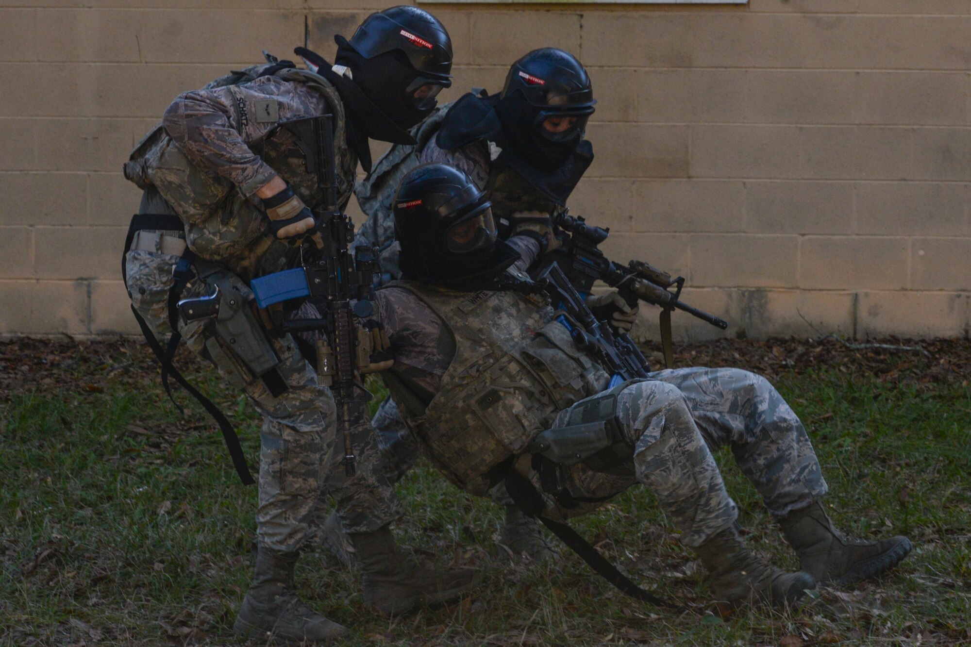 Airmen from the 822d Base Defense Squadron recover an injured teammate during a force-on-force training exercise at the military operations in urban terrain village, Dec. 10, 2015, at Moody Air Force Base, Ga. The quarterly training is used to keep Airmen qualified on their weapons and provide a simulated combat environment to practice potential scenarios. (U.S. Air Force photo by Airman 1st Class Janiqua P. Robinson/Released)