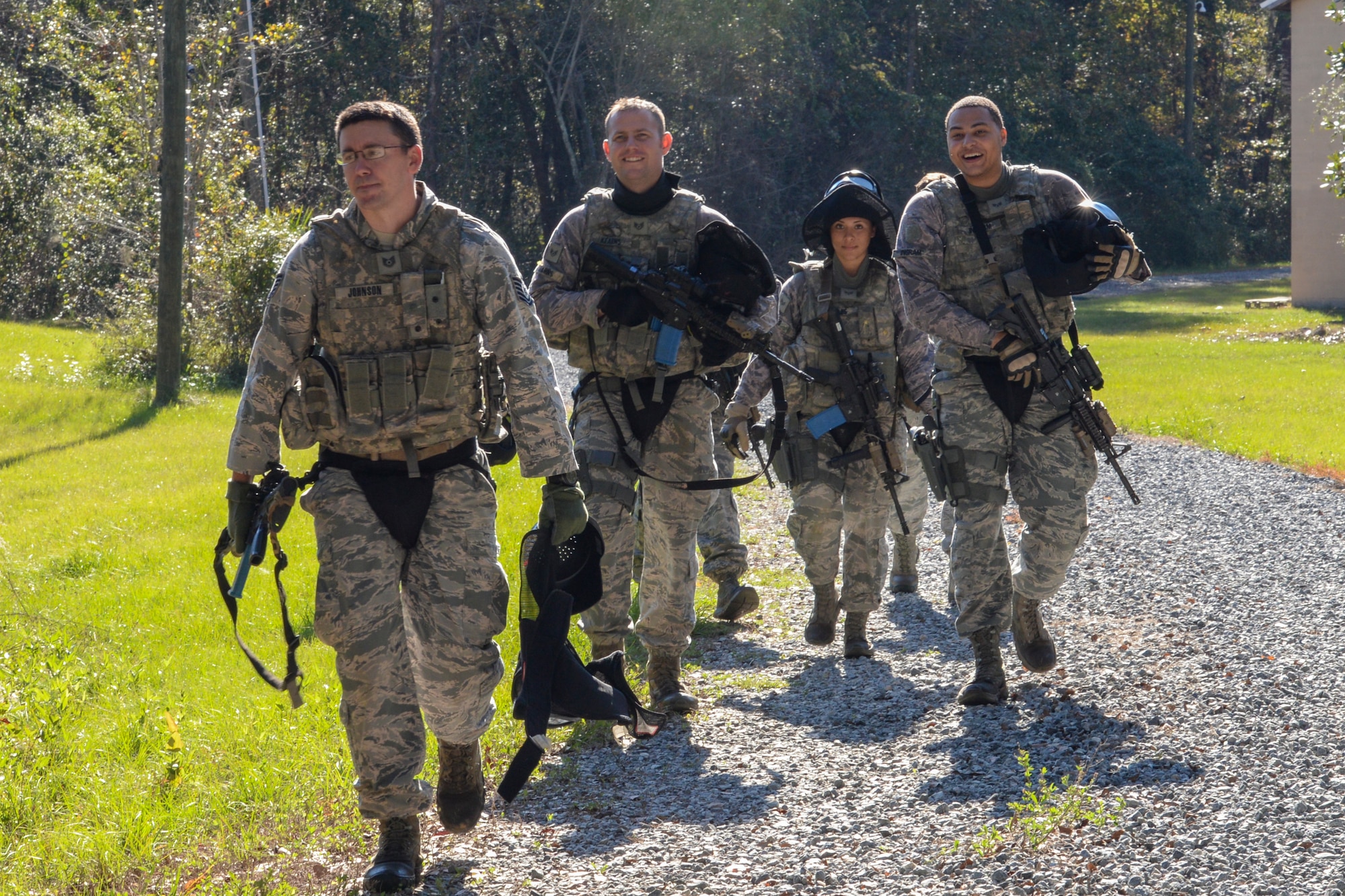 Airmen from the 822d Base Defense Squadron prepare to be debriefed at the end of a force-on- force training exercise at the military operations in urban terrain village, Dec. 10, 2015, at Moody Air Force Base, Ga. Airmen fired simulated rounds from M9 Beretta pistols and M4 carbines during the quarterly exercise to stay qualified on their weapons. (U.S. Air Force photo by Airman 1st Class Janiqua P. Robinson/Released)